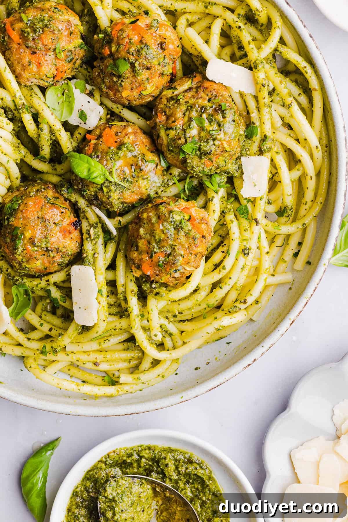 Oven-Baked Chicken Pesto Meatballs 2 Mouthwatering Baked Chicken Pesto Meatballs made with tender ground chicken, garlicky basil pesto, fresh veggies and parmesan cheese. Juicy, flavorful and make the perfect weeknight meal served over pasta or with rice!