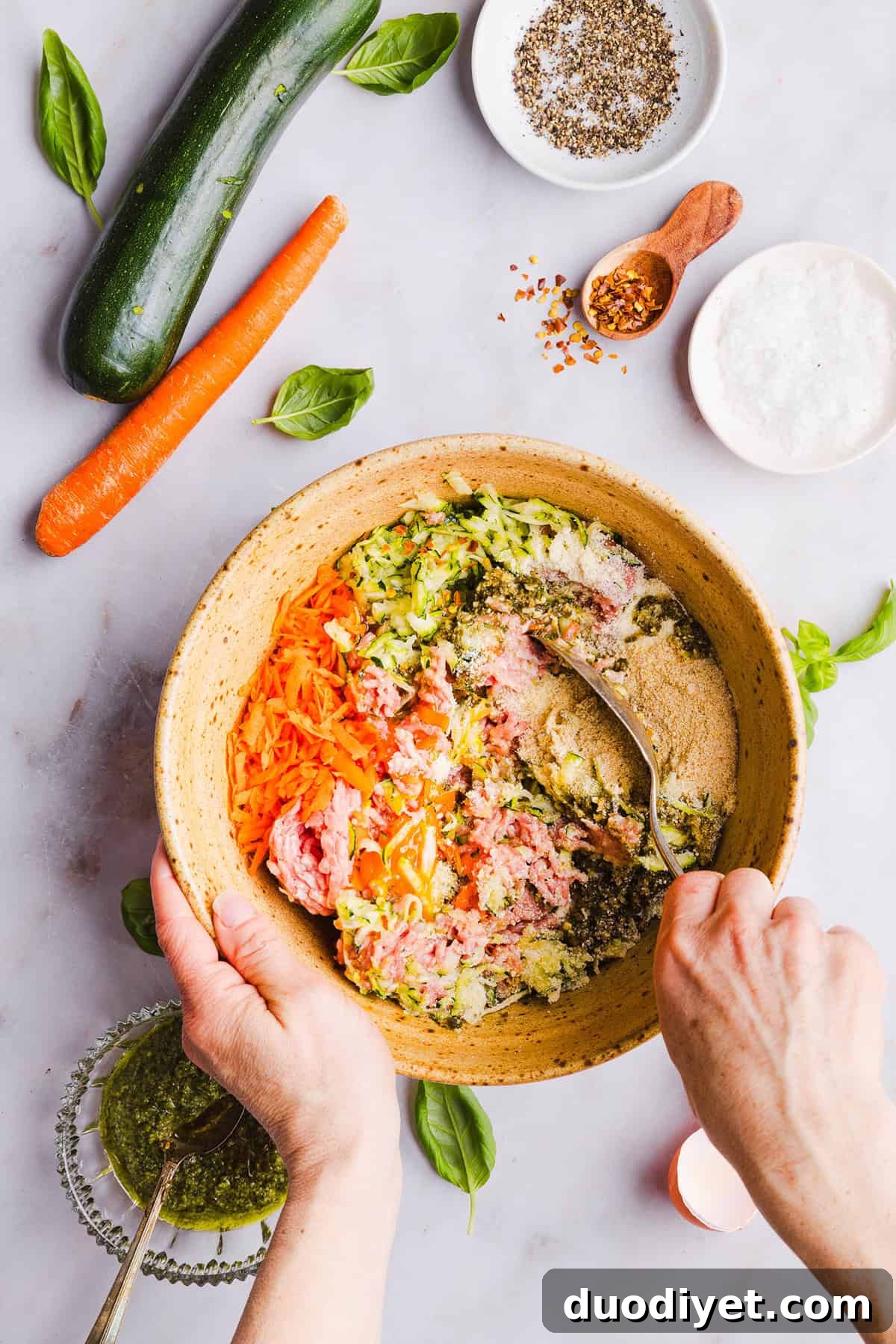 Oven-Baked Chicken Pesto Meatballs 3 Mouthwatering Baked Chicken Pesto Meatballs made with tender ground chicken, garlicky basil pesto, fresh veggies and parmesan cheese. Juicy, flavorful and make the perfect weeknight meal served over pasta or with rice!