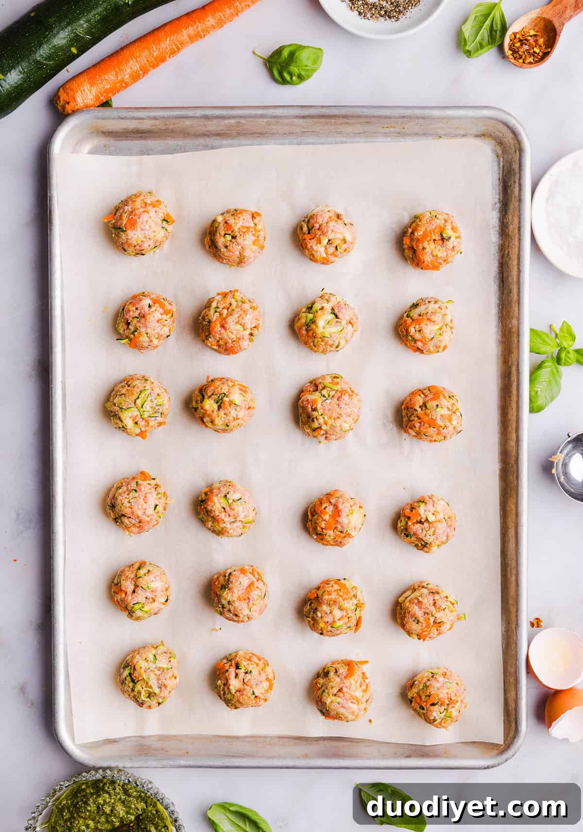 Oven-Baked Chicken Pesto Meatballs 4 Mouthwatering Baked Chicken Pesto Meatballs made with tender ground chicken, garlicky basil pesto, fresh veggies and parmesan cheese. Juicy, flavorful and make the perfect weeknight meal served over pasta or with rice!