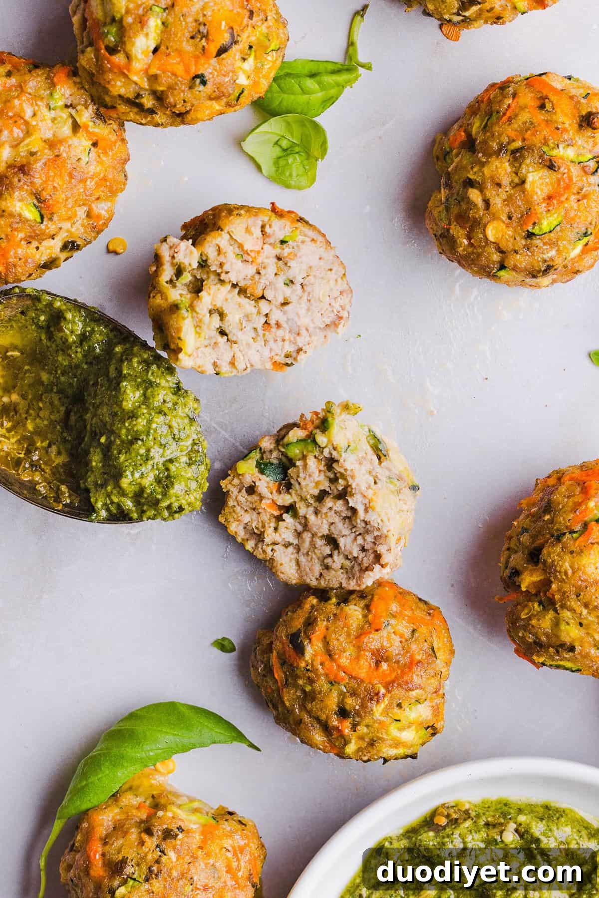 Oven-Baked Chicken Pesto Meatballs 6 Mouthwatering Baked Chicken Pesto Meatballs made with tender ground chicken, garlicky basil pesto, fresh veggies and parmesan cheese. Juicy, flavorful and make the perfect weeknight meal served over pasta or with rice!