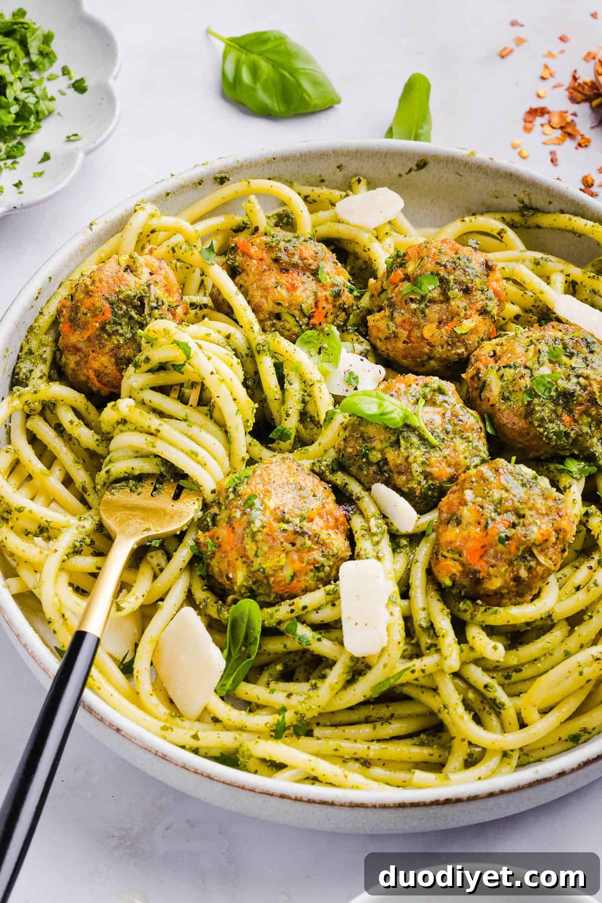 Oven-Baked Chicken Pesto Meatballs 7 Mouthwatering Baked Chicken Pesto Meatballs made with tender ground chicken, garlicky basil pesto, fresh veggies and parmesan cheese. Juicy, flavorful and make the perfect weeknight meal served over pasta or with rice!