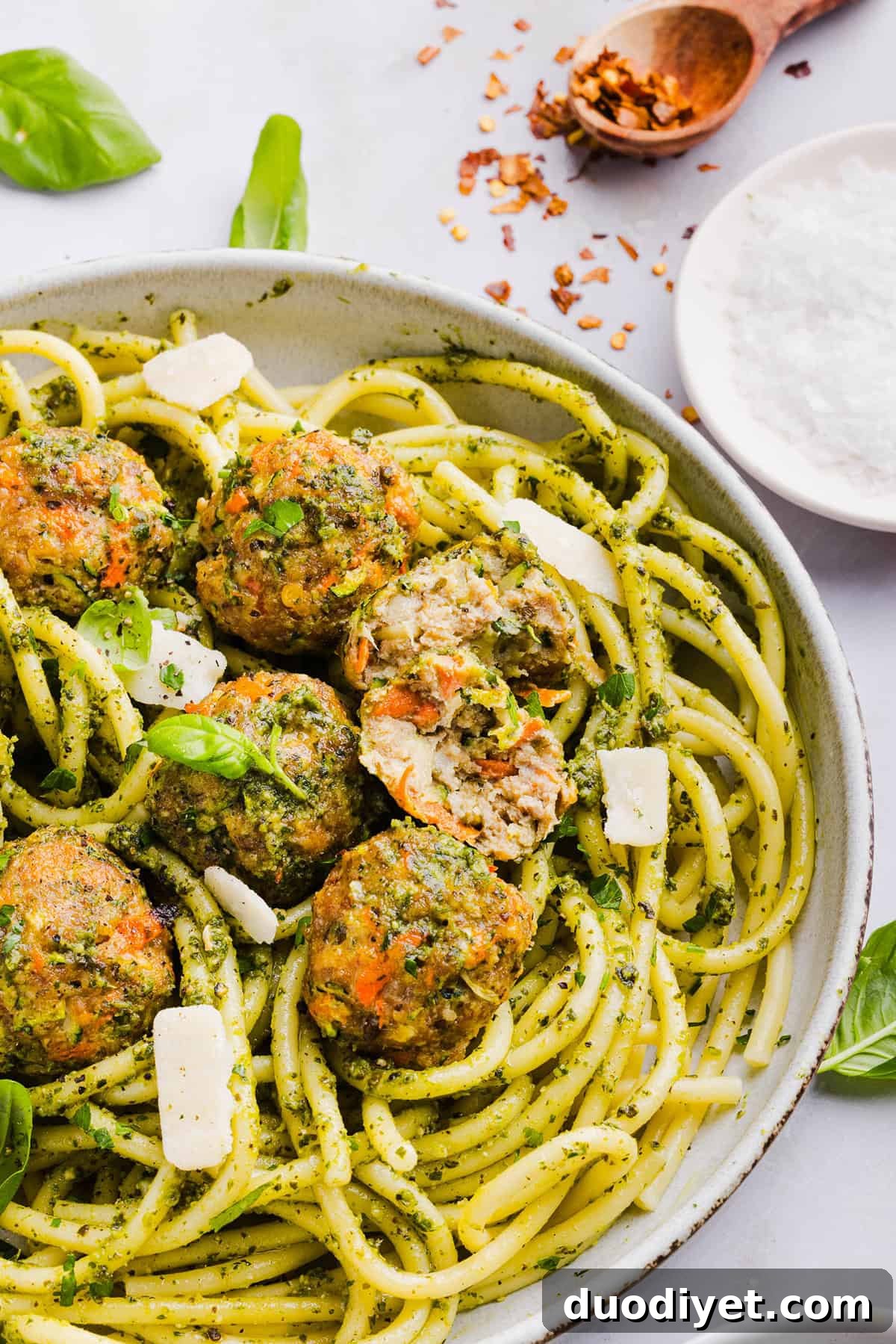 Oven-Baked Chicken Pesto Meatballs 8 Mouthwatering Baked Chicken Pesto Meatballs made with tender ground chicken, garlicky basil pesto, fresh veggies and parmesan cheese. Juicy, flavorful and make the perfect weeknight meal served over pasta or with rice!