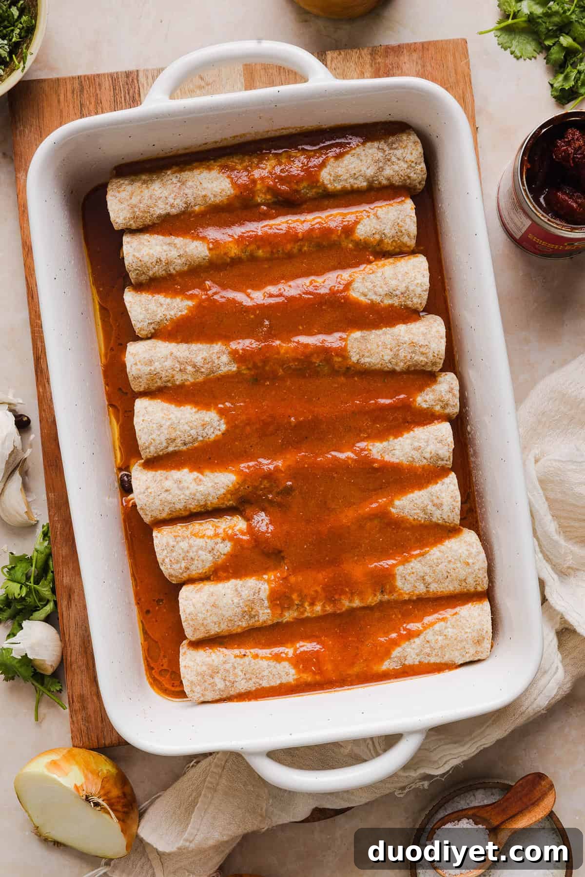 This Healthy Chicken Enchilada recipe is a family favorite made with wholesome, flavorful ingredients for the perfect weeknight meal! The homemade enchilada sauce tastes absolutely amazing! 