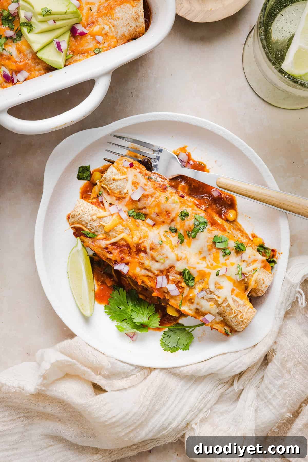 This Healthy Chicken Enchilada recipe is a family favorite made with wholesome, flavorful ingredients for the perfect weeknight meal! The homemade enchilada sauce tastes absolutely amazing! 