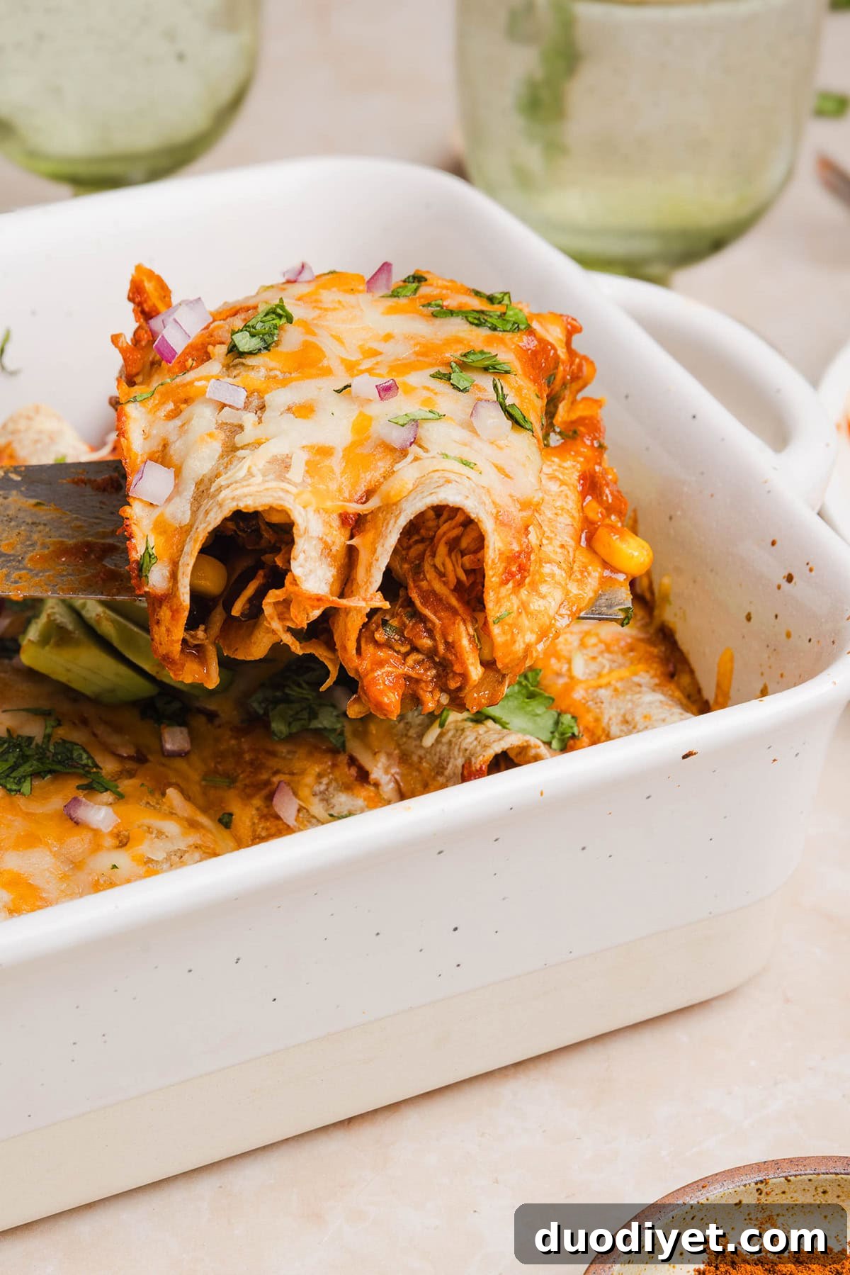 This Healthy Chicken Enchilada recipe is a family favorite made with wholesome, flavorful ingredients for the perfect weeknight meal! The homemade enchilada sauce tastes absolutely amazing! 