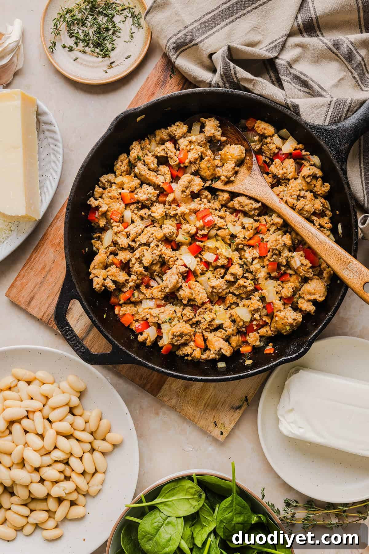 Creamy Cheesy Sausage and Bean Dip Recipe 4 This Cheesy Sausage Bean Dip is the ultimate party appetizer! Made with flavorful spicy sausage, sautéed onions, bell peppers, garlic and spinach, along with cream cheese and white beans. Topped with freshly grated parmesan cheese and served with toasted bread or Frito corn chips!