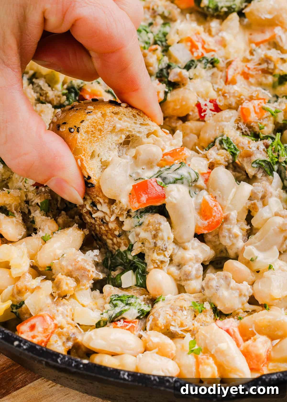 Creamy Cheesy Sausage and Bean Dip Recipe 6 This Cheesy Sausage Bean Dip is the ultimate party appetizer! Made with flavorful spicy sausage, sautéed onions, bell peppers, garlic and spinach, along with cream cheese and white beans. Topped with freshly grated parmesan cheese and served with toasted bread or Frito corn chips!