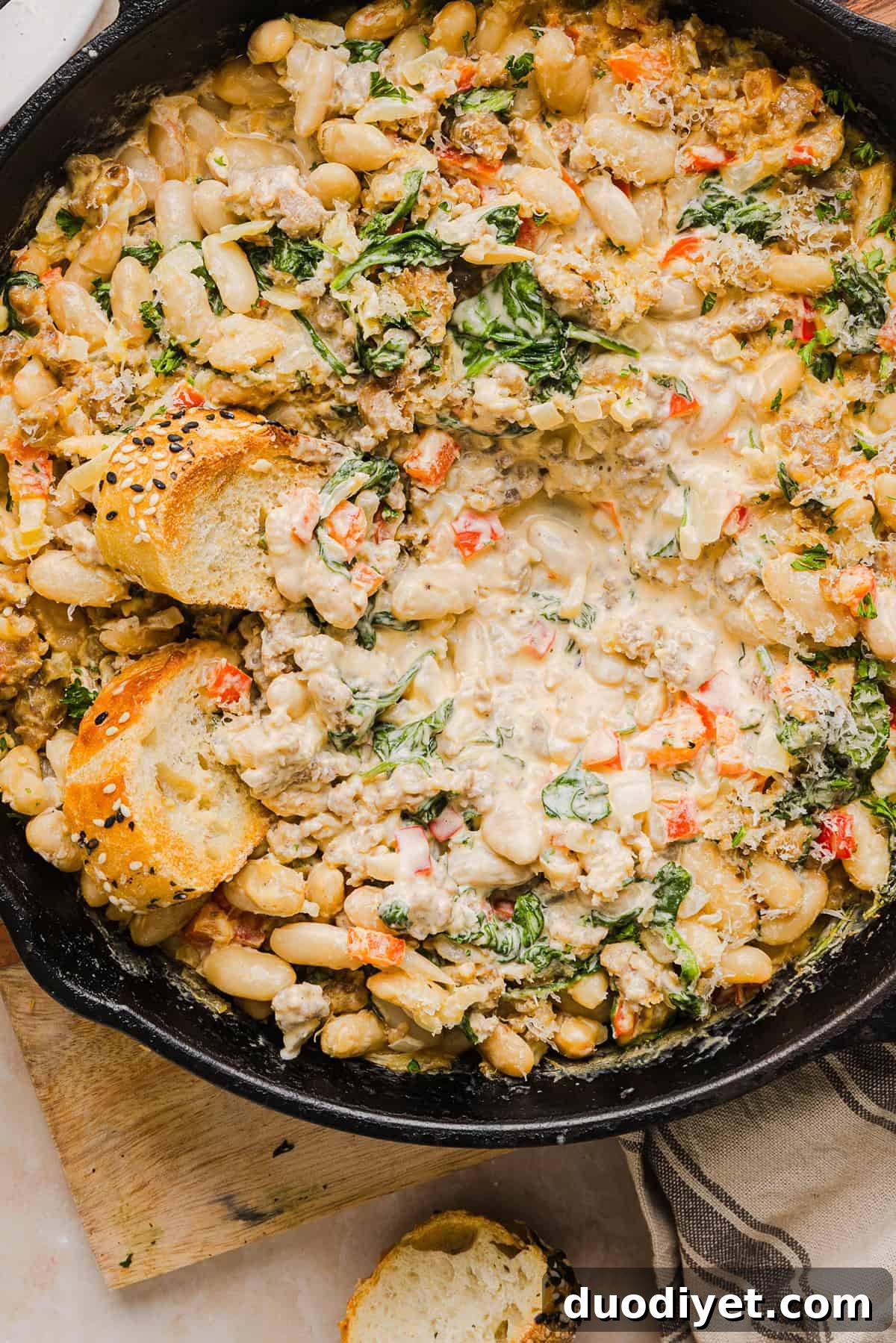 Cheesy Sausage and Bean Dip Recipe 9 A scoop of cheesy sausage bean dip on a chip