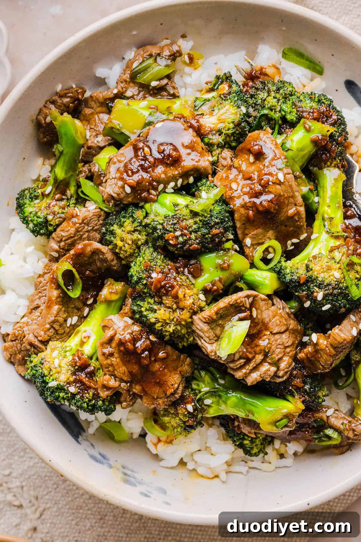 You'll love this Healthy Beef and Broccoli recipe made with tender flank steak, crisp broccoli and a savory garlic ginger sauce.  A quick and easy weeknight dinner that tastes better than take-out and comes together in under 30 minutes!