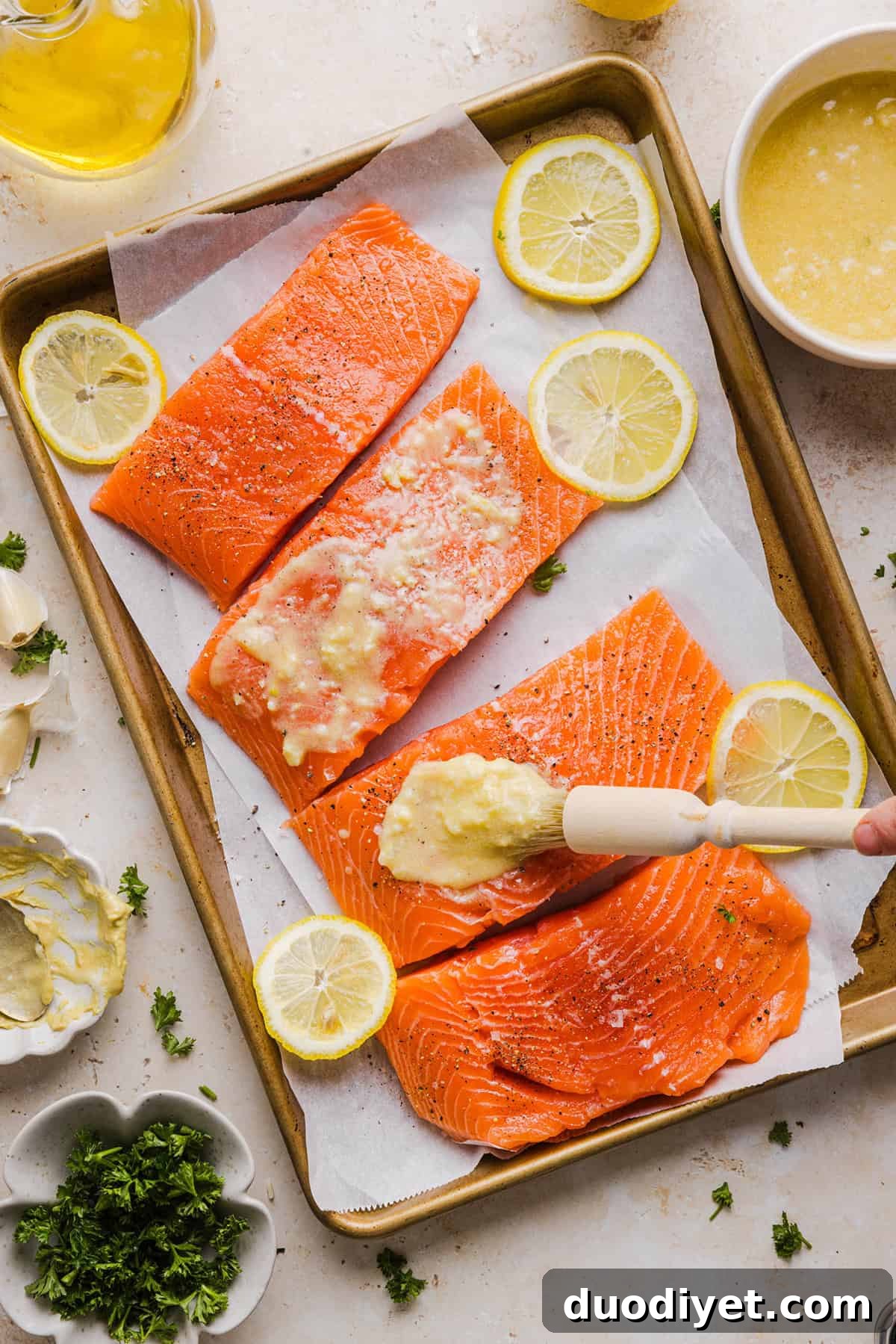 Oven-Baked Garlic Butter Salmon 3 Garlic Butter Baked Salmon plated with lemon and parsley