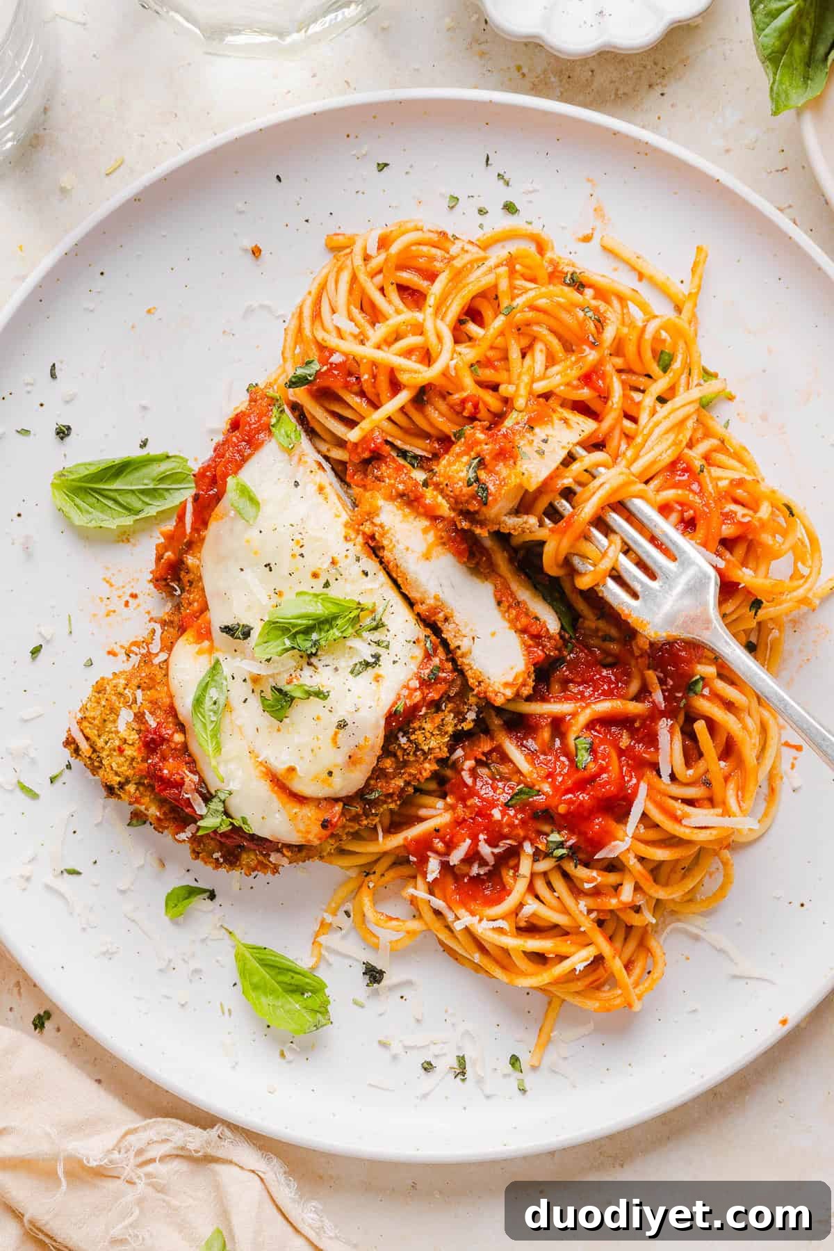 This Baked Chicken Parmesan is made with tender juicy chicken, rich marinara sauce and melty cheese with a crisp coating that tastes delicious! This chicken is baked, not fried, and easily comes together in under 30 minutes! 