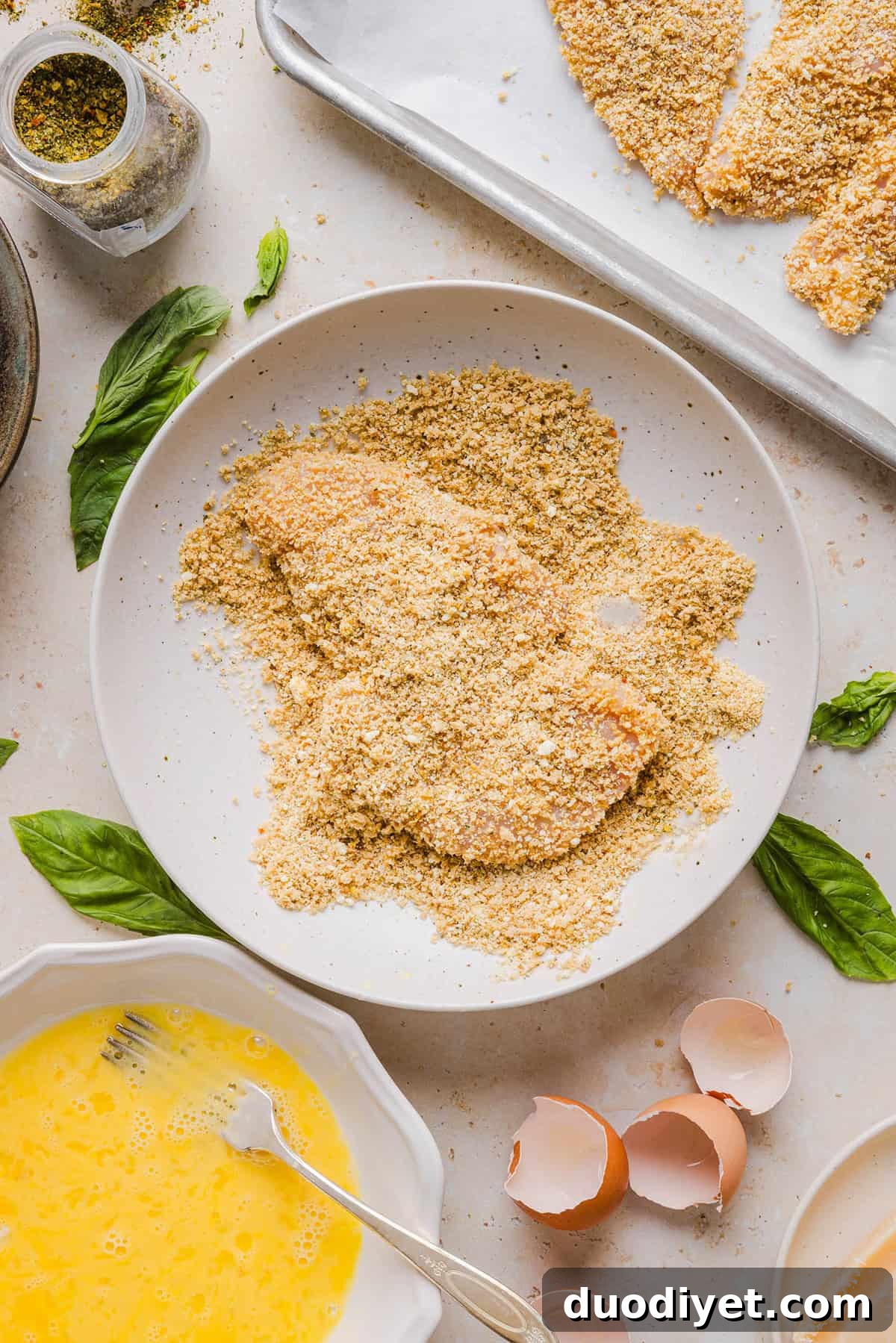 Easy Baked Chicken Parmesan made with tender juicy chicken, rich marinara sauce and melty cheese with a crisp coating that tastes delicious! This chicken is baked, not fried, and easily comes together in under 30 minutes! 