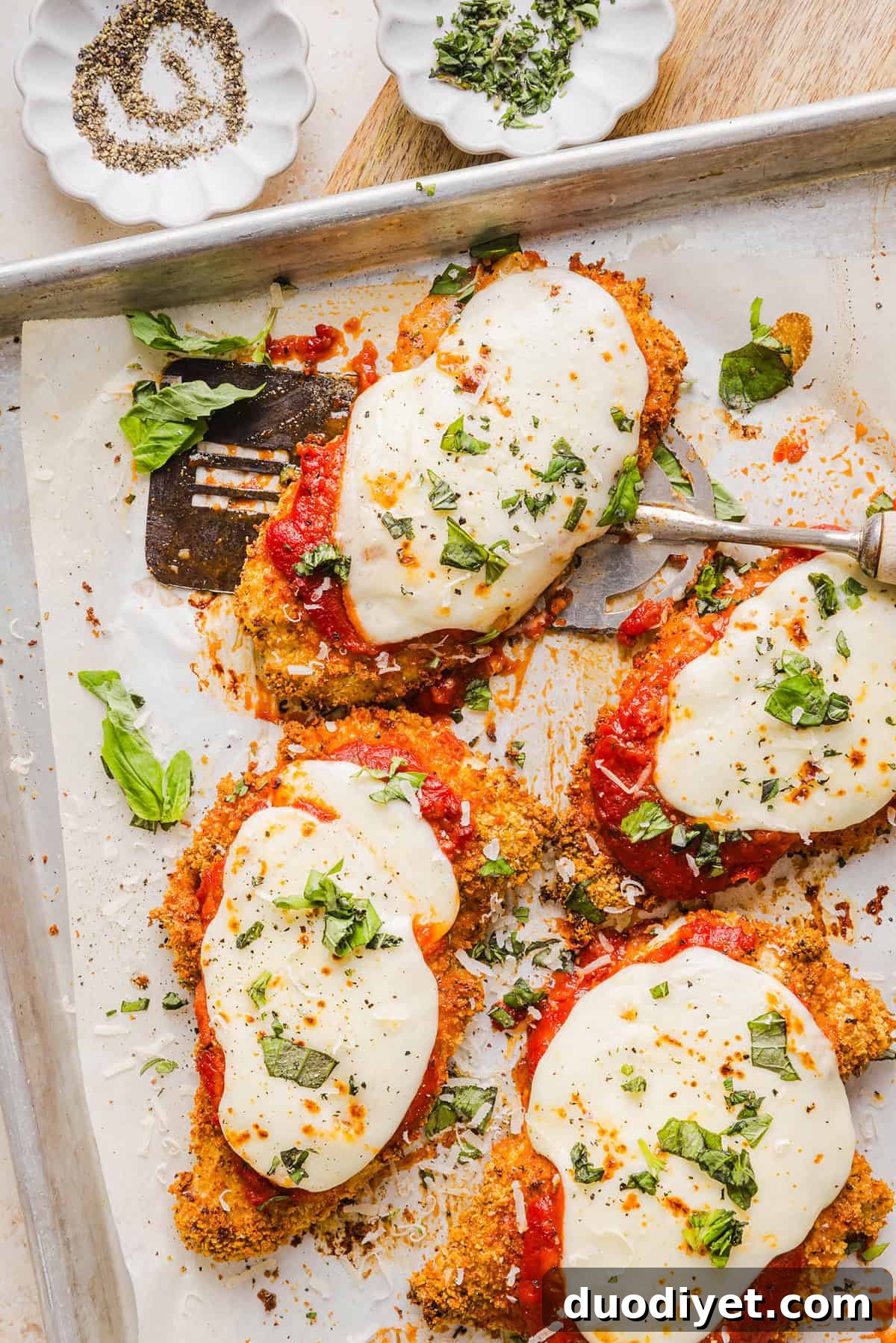 Easy Baked Chicken Parmesan made with tender juicy chicken, rich marinara sauce and melty cheese with a crisp coating that tastes delicious! This chicken is baked, not fried, and easily comes together in under 30 minutes! 