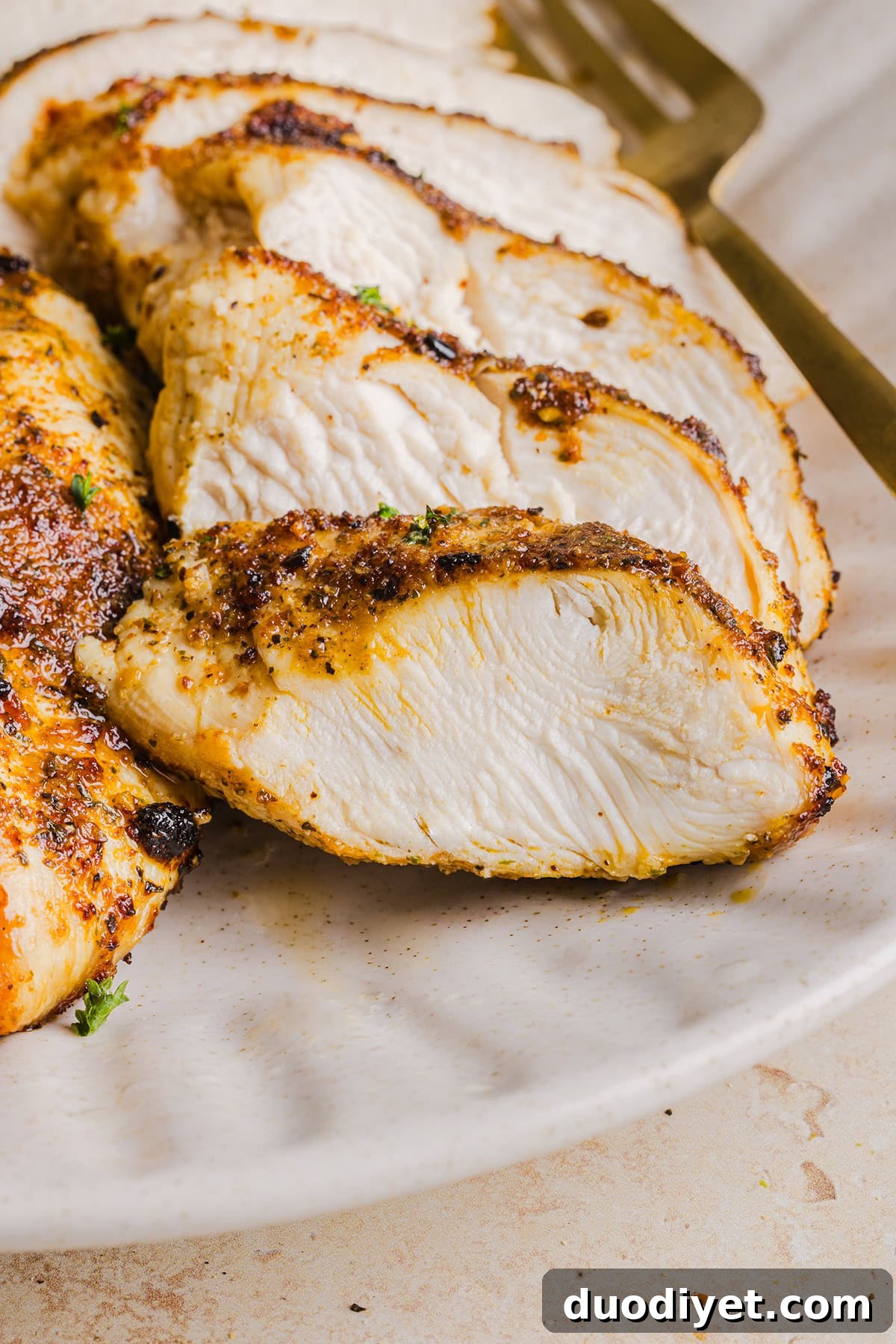 Air fryer chicken breasts resting before slicing.