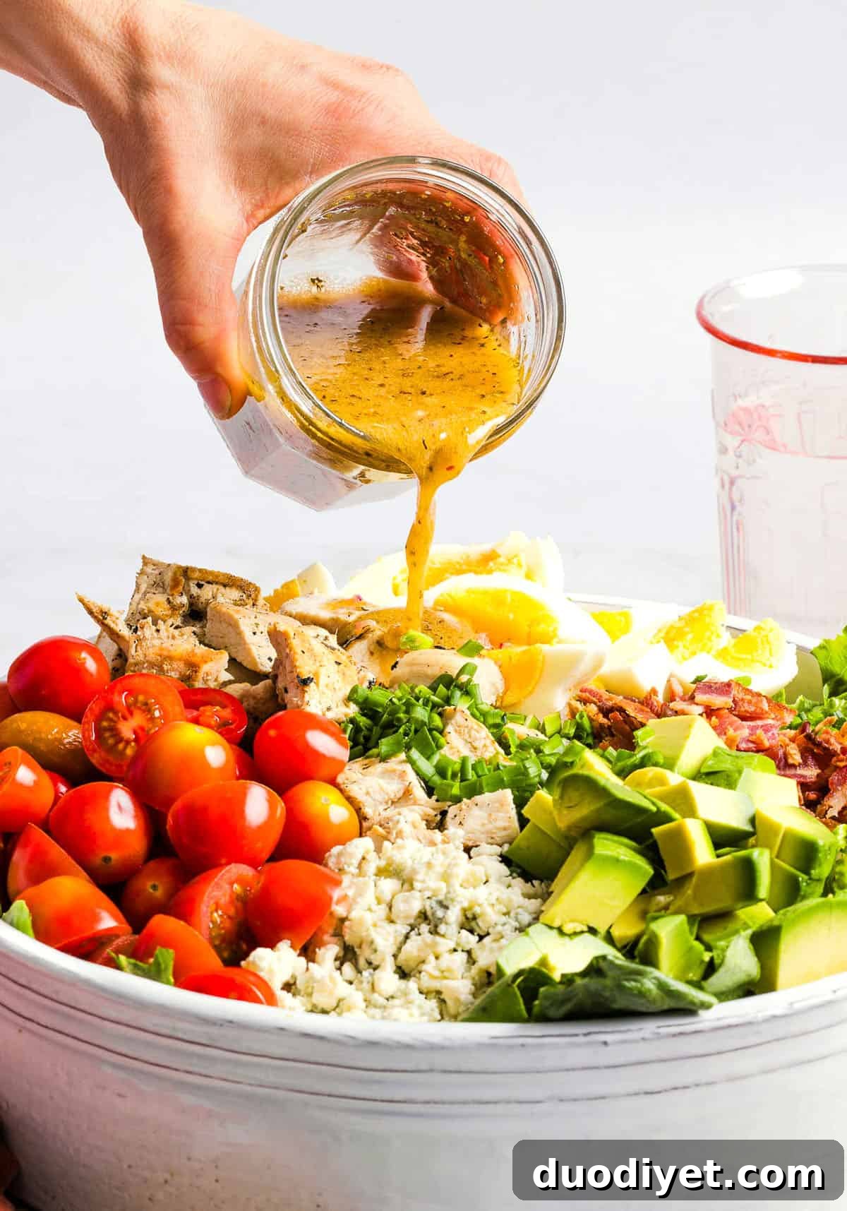 Chicken Cobb Salad Recipe with Avocado and Bacon 4 Protein-packed Chicken Cobb Salad loaded with tender chicken, crispy bacon, creamy avocado and tangy blue cheese all tossed in a delicious red wine vinaigrette! A fresh, hearty and satisfying salad that is perfect for lunch or a light dinner.