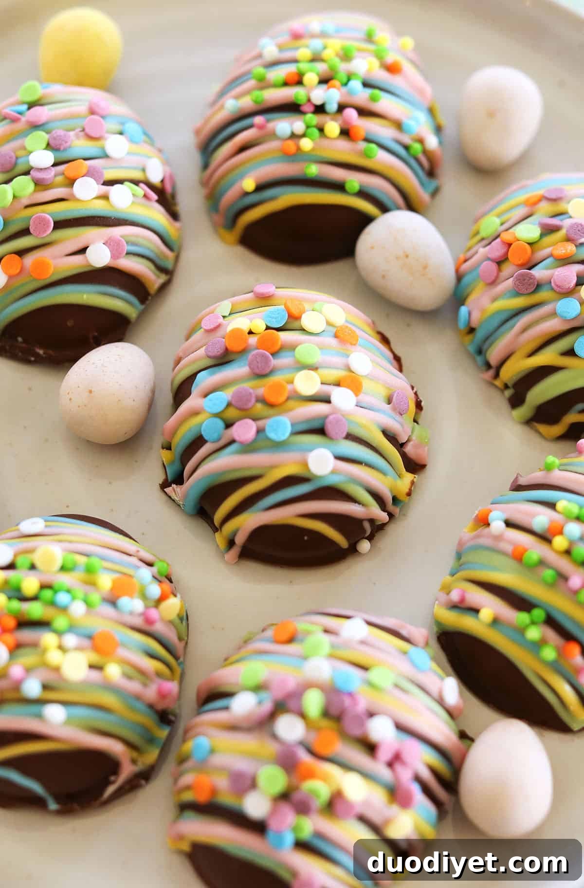 Chocolate peanut butter eggs stacked on parchment