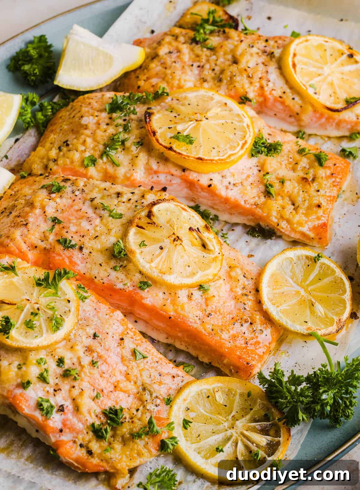 The most flavorful Garlic Butter Baked Salmon that is tender, flaky and coated in a rich garlicky sauce with lemon and Dijon. This simple healthy recipe easily comes together in under 20 minutes!