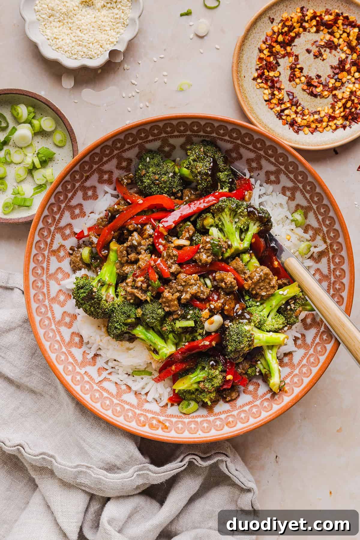 Close-up of Mongolian beef with vegetables and sauce.