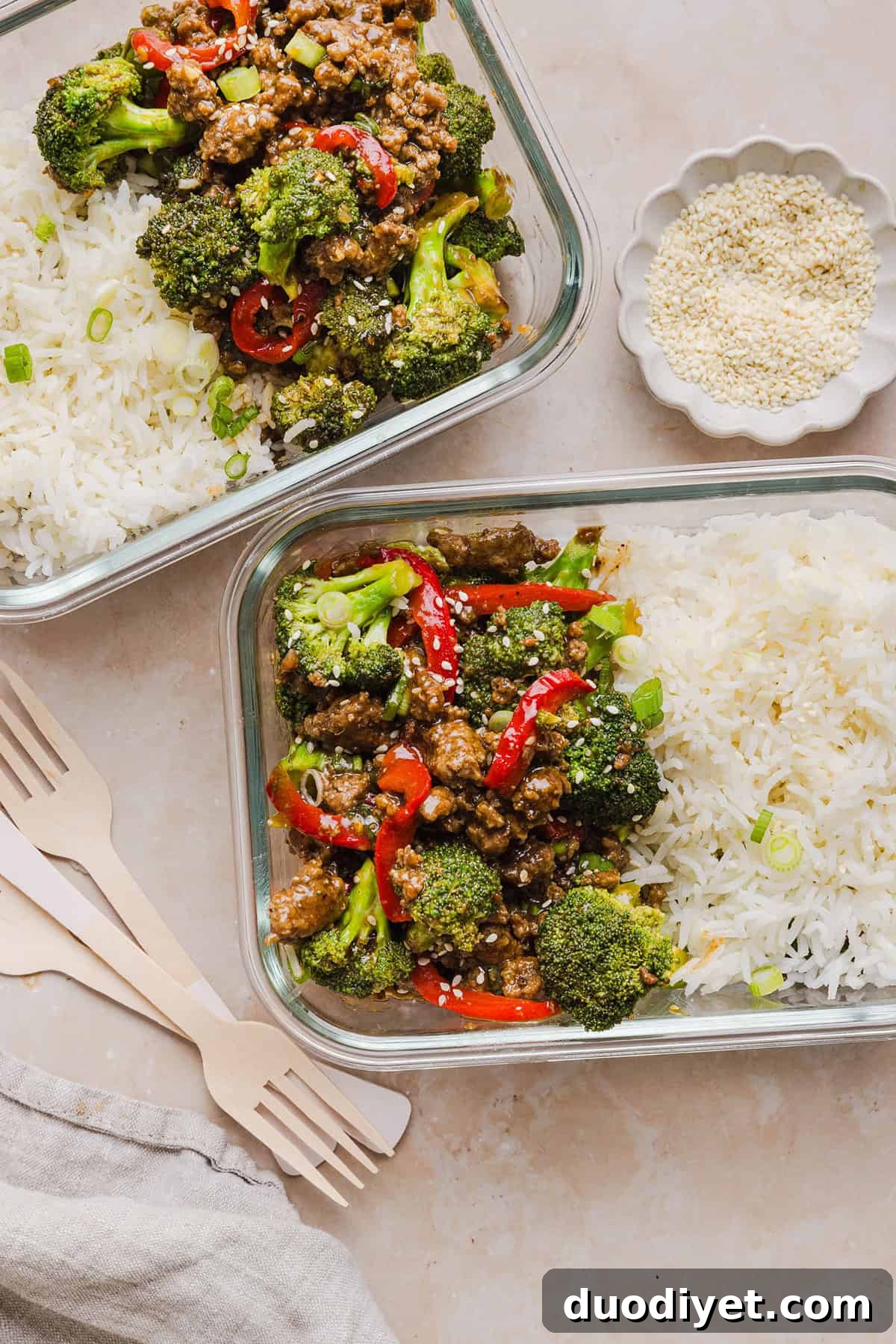 Healthy Mongolian Ground Beef Bowls served with rice and garnishes.