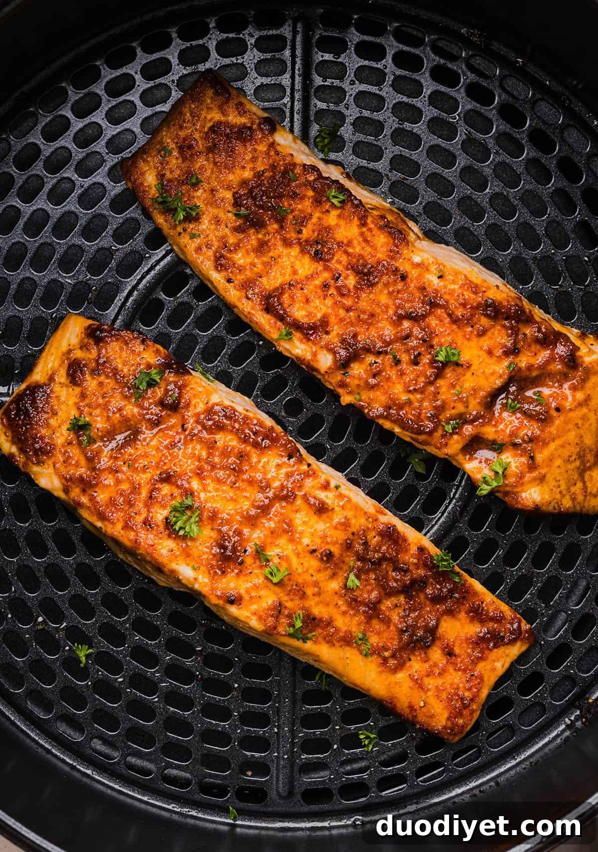 Seasoned salmon fillets ready for the air fryer.