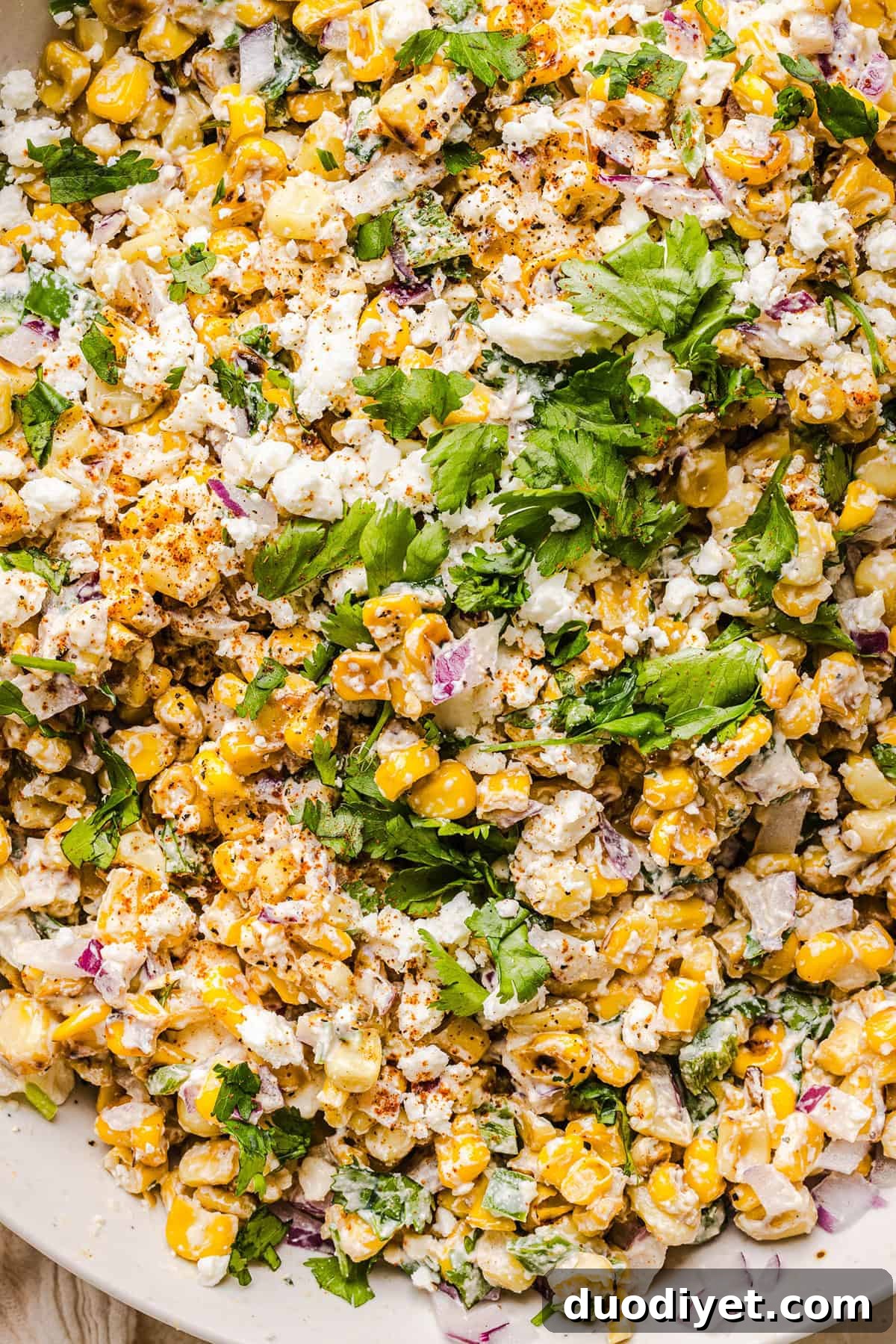 Zesty Mexican Street Corn Elote Salad with Lime and Cotija 7 Large bowl of Mexican street corn salad with garnishes