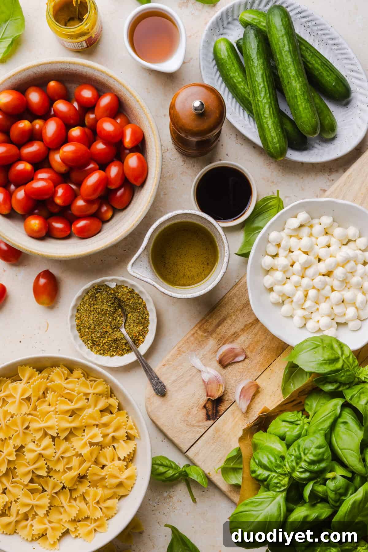 Close-up of Caprese Pasta Salad ingredients: tomatoes, mozzarella, basil, cucumbers and pasta