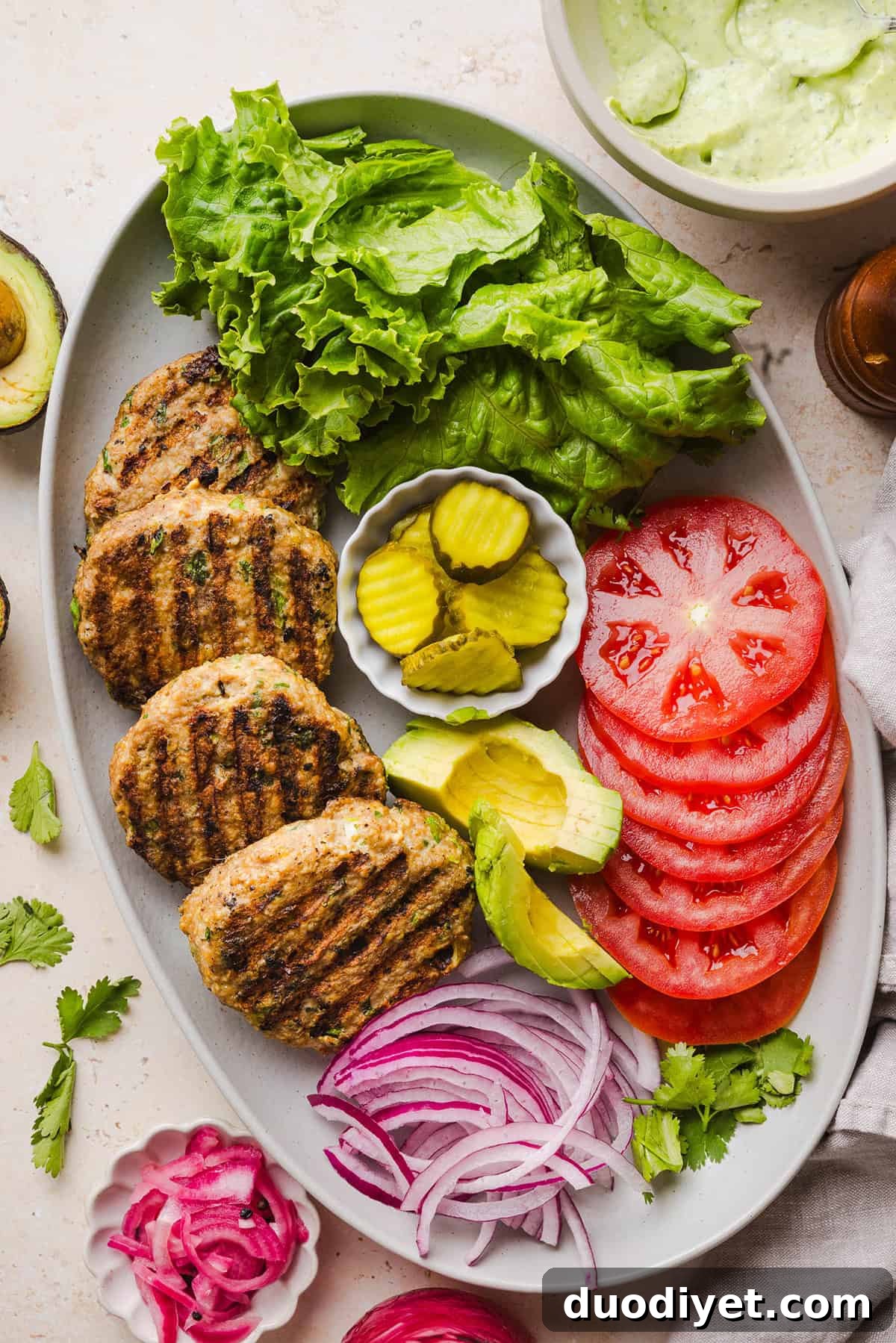 Grilled Cilantro Lime Chicken Burgers 6 These Cilantro Lime Chicken Burgers are juicy, flavorful, and topped with a creamy avocado cilantro sauce. Made with lean ground chicken, fresh cilantro, green onions, and lime zest, these burgers are perfect for summer grilling or an easy weeknight meal!