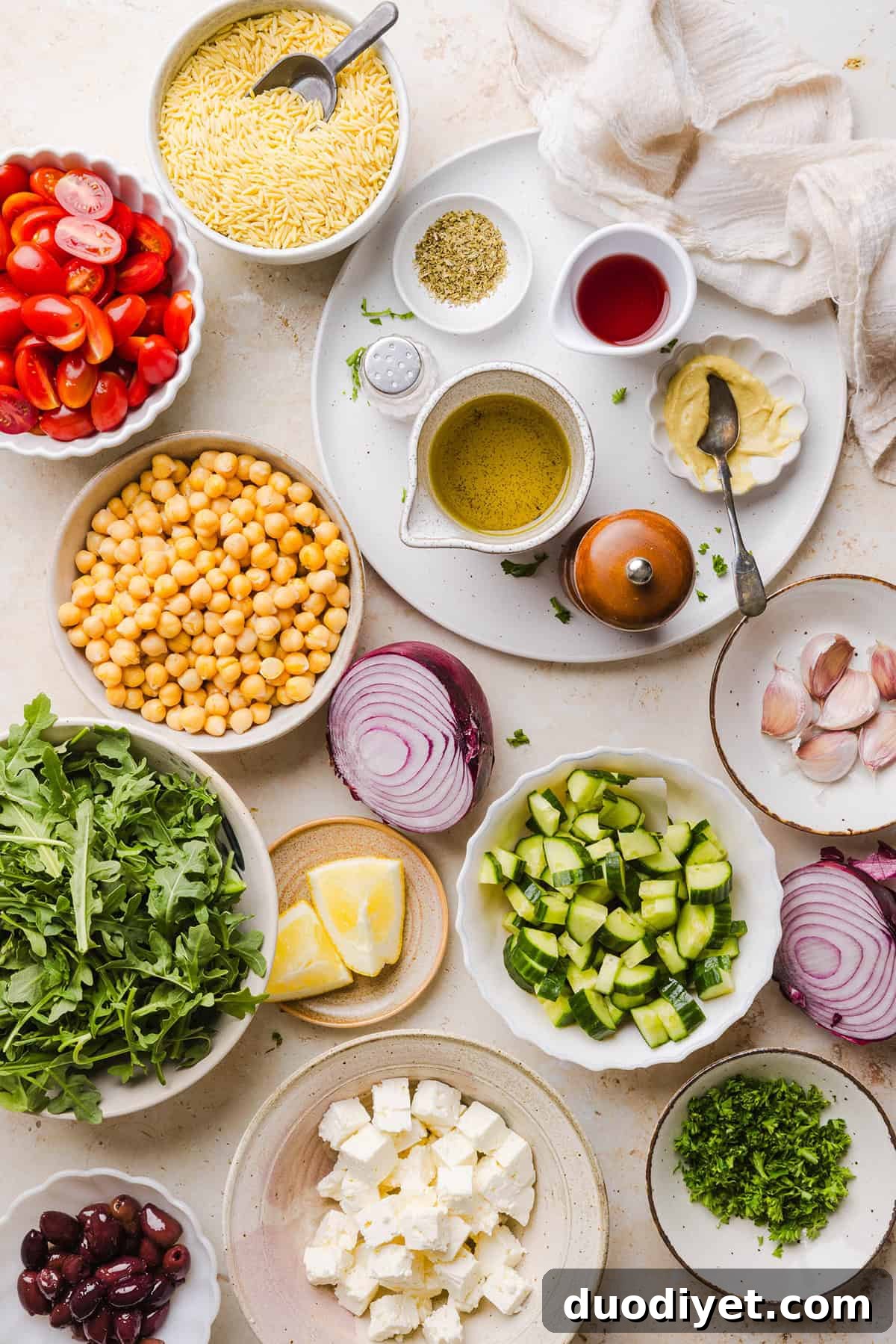This Easy Greek Orzo Salad is packed with fresh veggies, chickpeas, feta, and the most delicious homemade lemon herb dressing. Perfect for meal prep, picnics, and summer cookouts!
