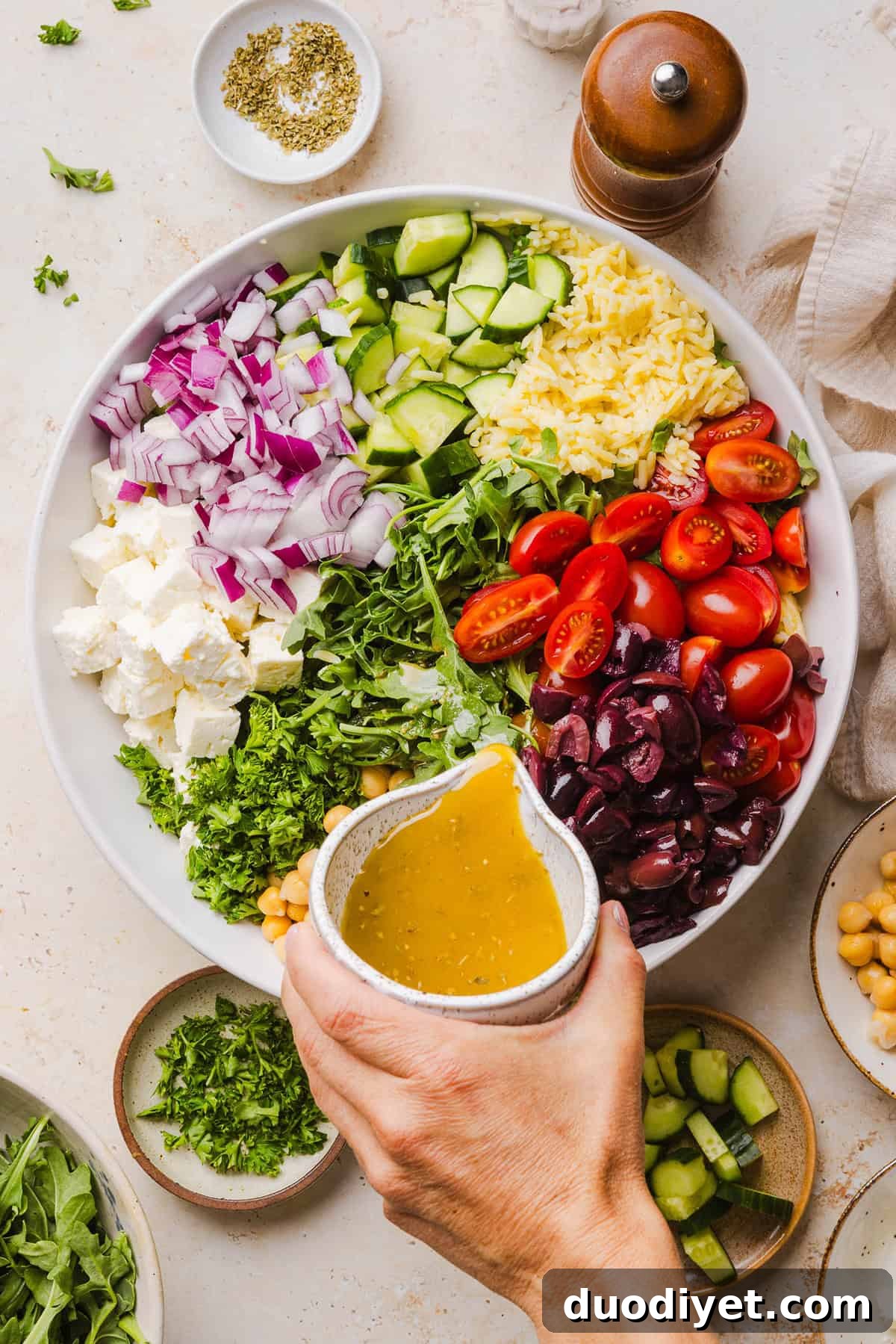 This Easy Greek Orzo Salad is packed with fresh veggies, chickpeas, feta, and the most delicious homemade lemon herb dressing. Perfect for meal prep, picnics, and summer cookouts!