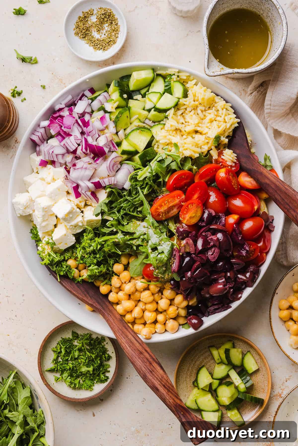 This Easy Greek Orzo Salad is packed with fresh veggies, chickpeas, feta, and the most delicious homemade lemon herb dressing. Perfect for meal prep, picnics, and summer cookouts!