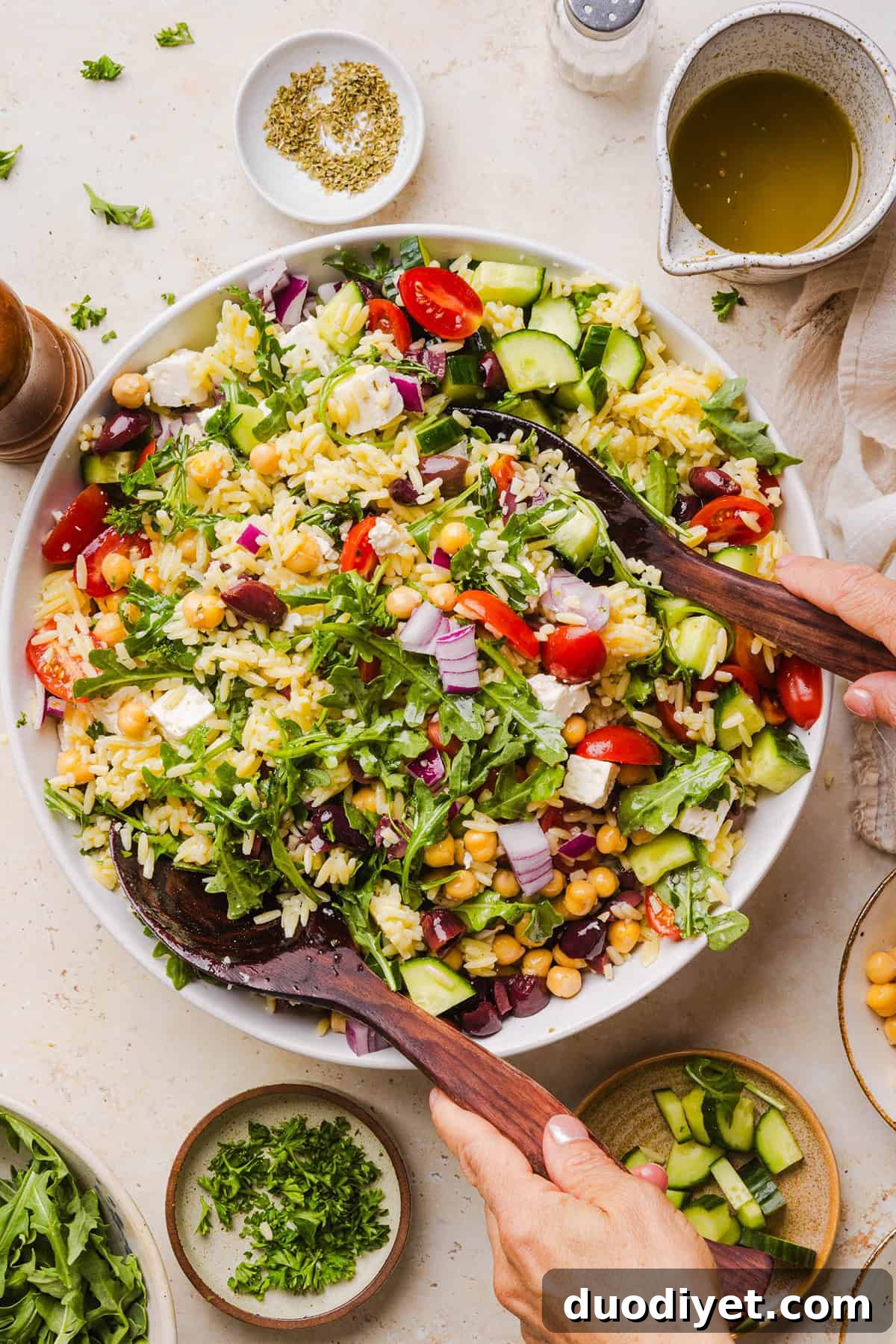 This Easy Greek Orzo Salad is packed with fresh veggies, chickpeas, feta, and the most delicious homemade lemon herb dressing. Perfect for meal prep, picnics, and summer cookouts!