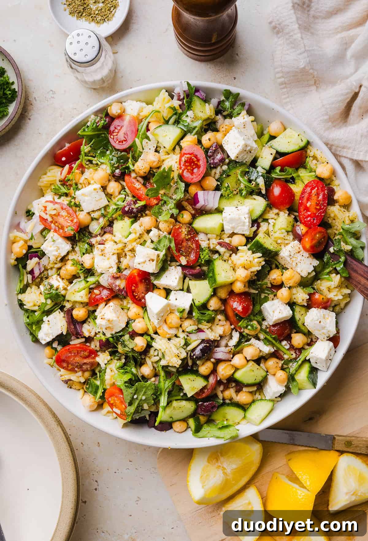 This Easy Greek Orzo Salad is packed with fresh veggies, chickpeas, feta, and the most delicious homemade lemon herb dressing. Perfect for meal prep, picnics, and summer cookouts!