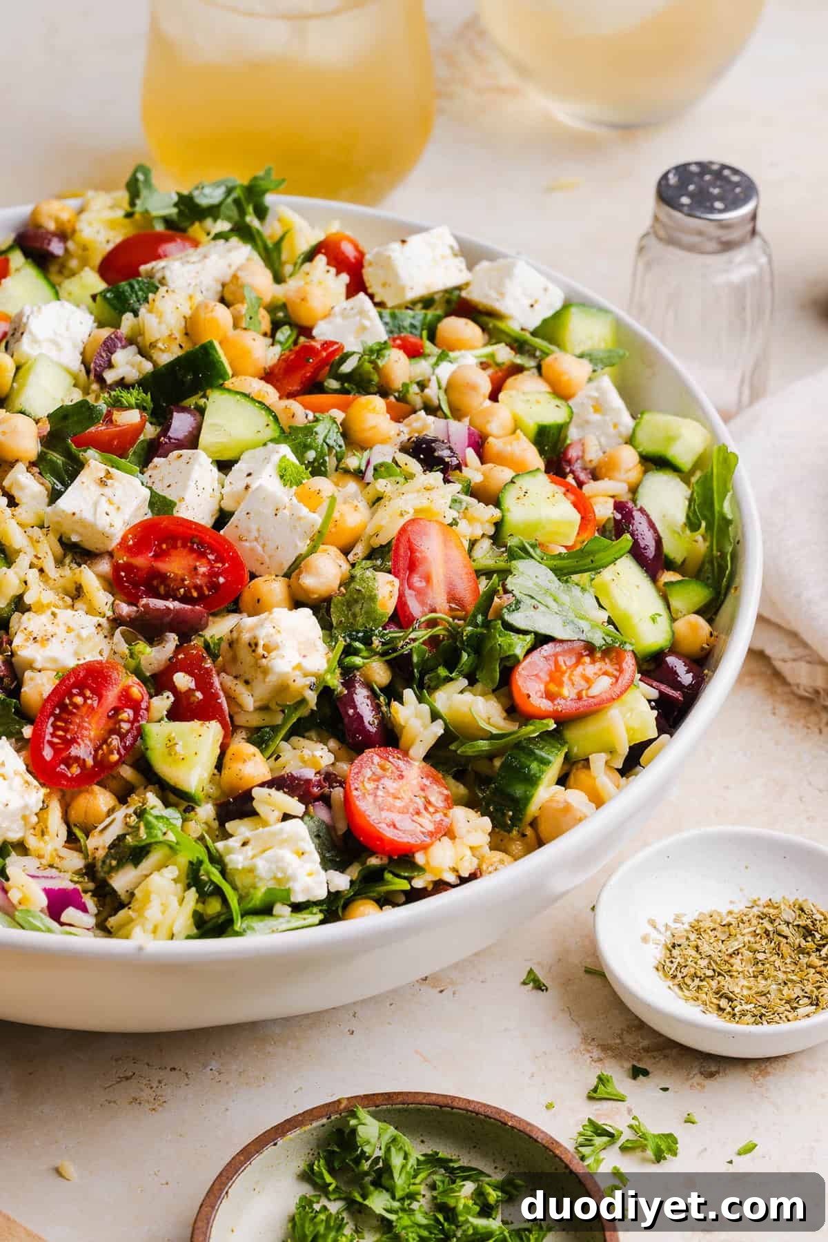 This Easy Greek Orzo Salad is packed with fresh veggies, chickpeas, feta, and the most delicious homemade lemon herb dressing. Perfect for meal prep, picnics, and summer cookouts!