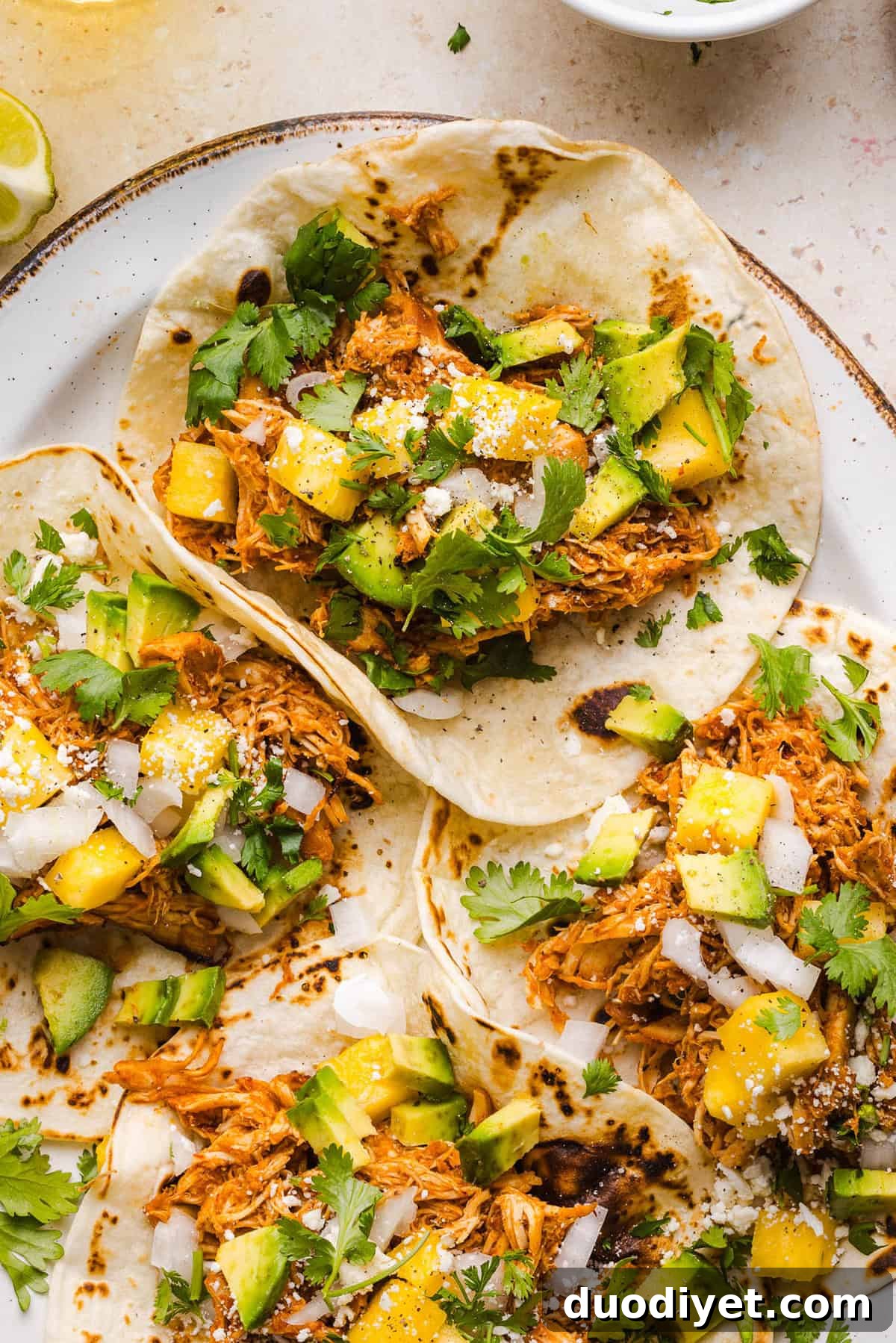 These Crock Pot Chicken Al Pastor Tacos are sweet, smoky, and incredibly flavorful! An easy slow cooker dinner made with juicy shredded chicken, fresh pineapple, chipotle peppers, and warm spices for a healthy, protein-packed dinner.