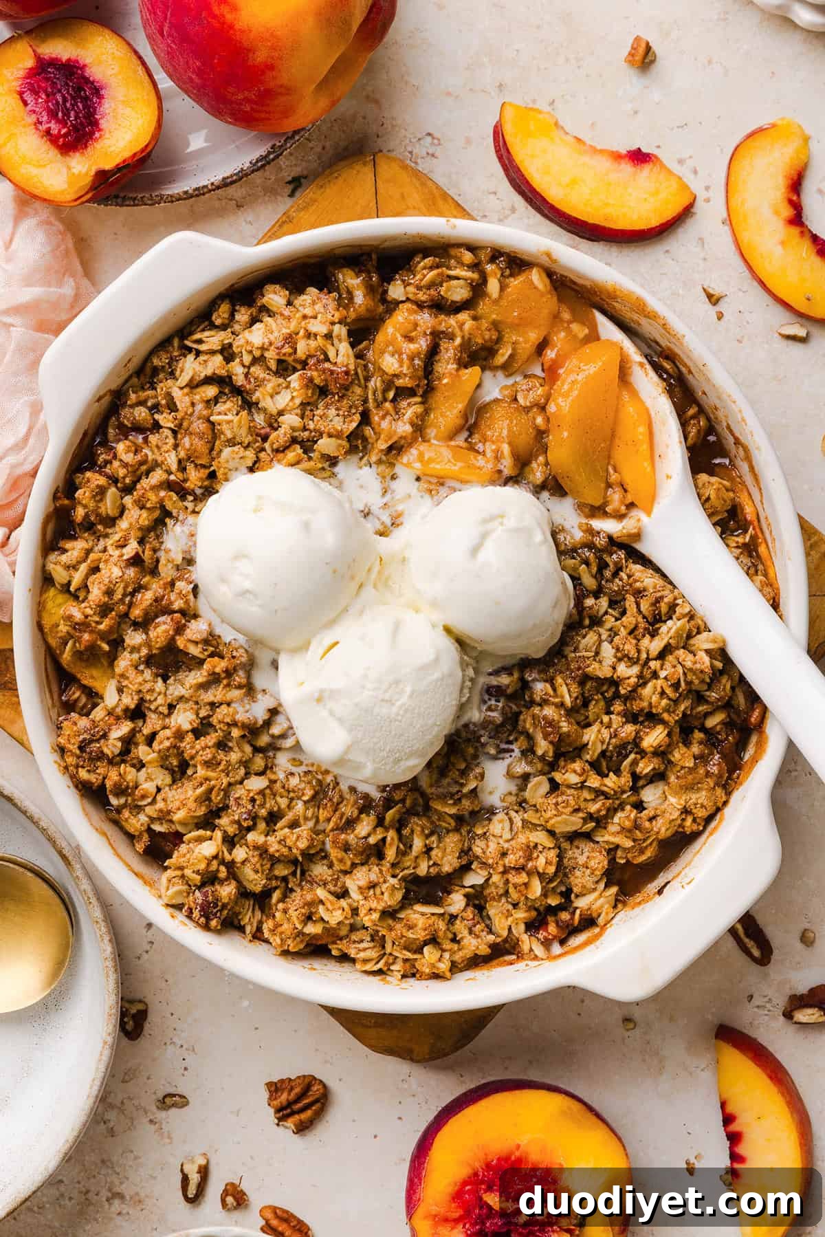 Warm peach crisp served with ice cream