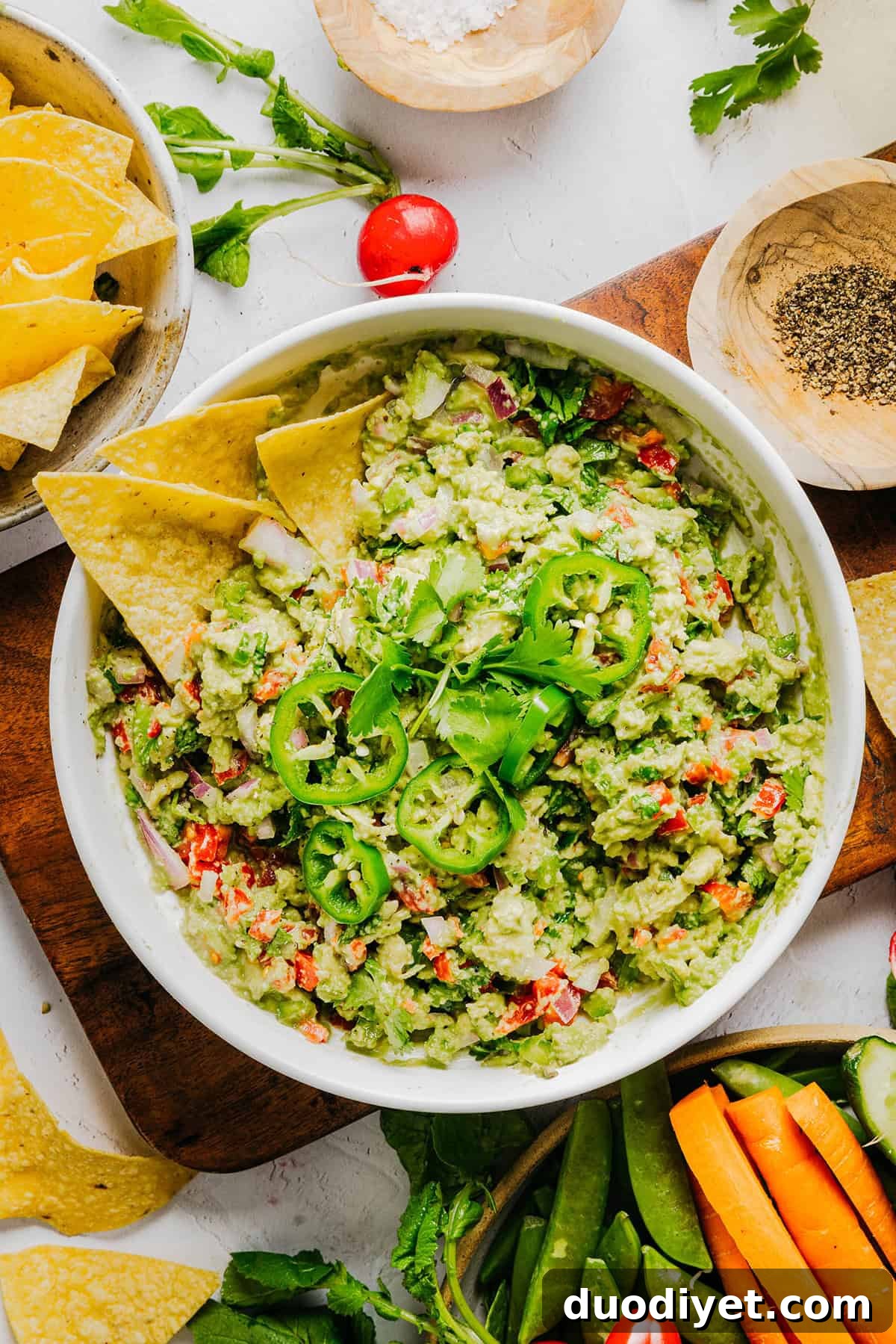 Chunky Guacamole Recipe with Tomato and Onion 2 The BEST Chunky Guacamole recipe made with ripe avocados, crisp veggies, zesty lime juice and a kick of heat.