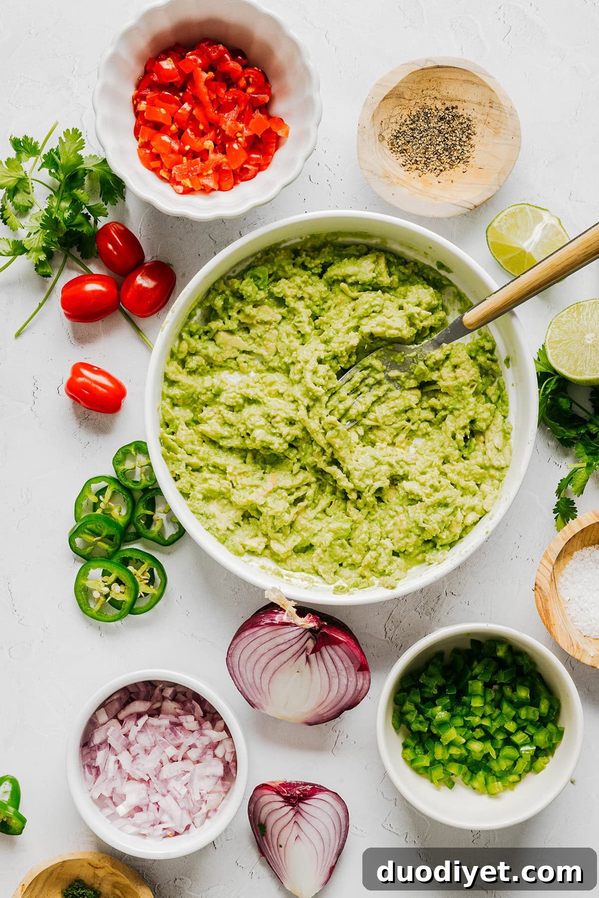 Chunky Guacamole Recipe with Tomato and Onion 3 Chunky guacamole in a bowl with chips.