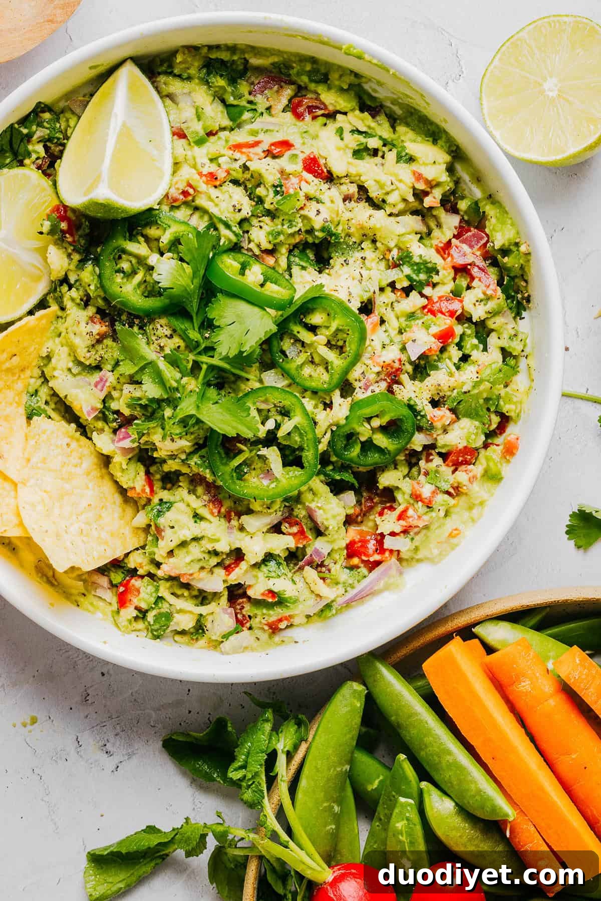 Chunky Guacamole Recipe with Tomato and Onion 8 Stored guacamole in a container.