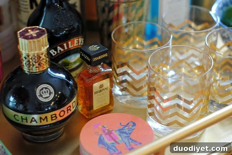 Bar cart staged for entertaining with glasses and decor