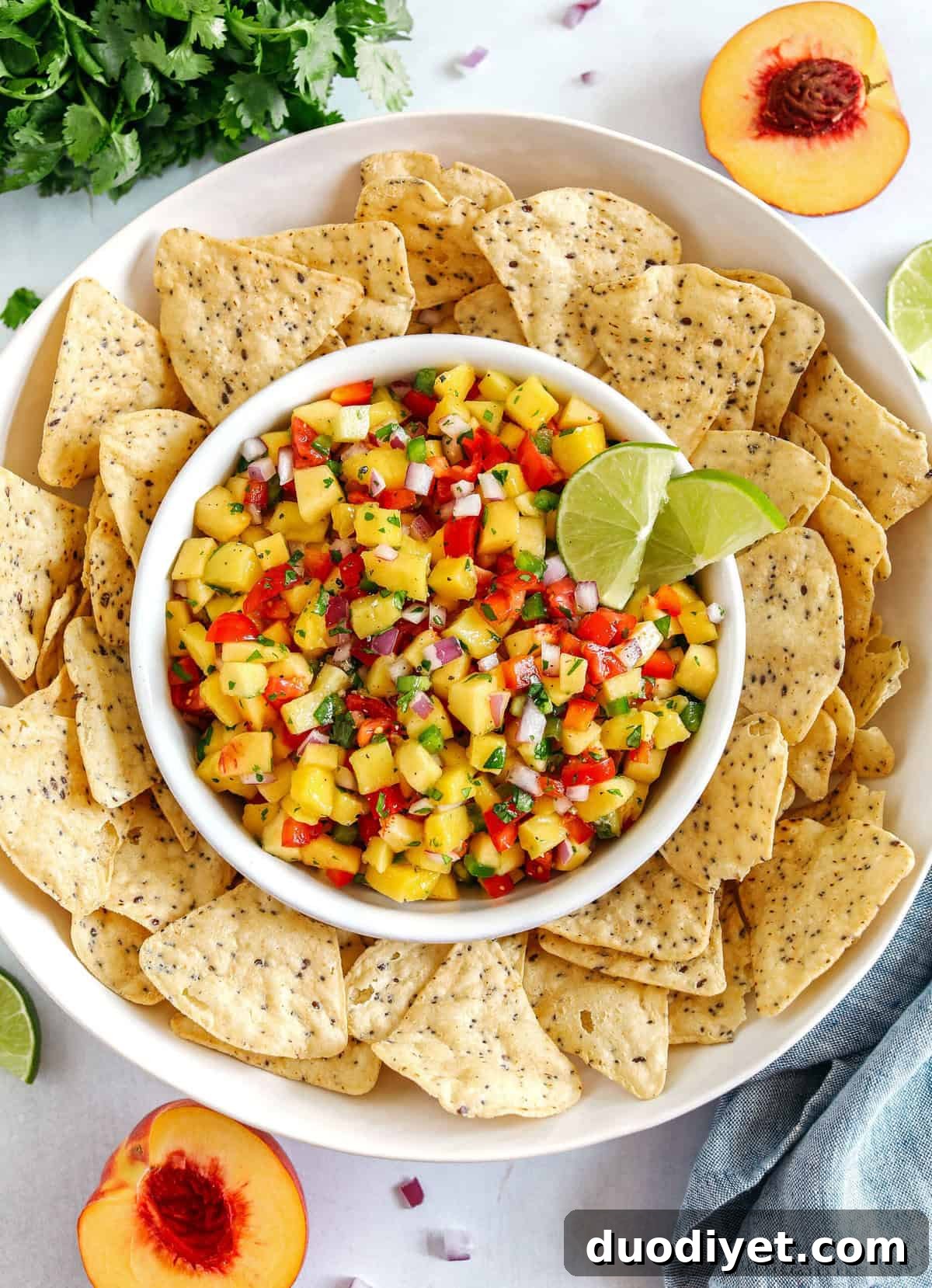 Fresh Peach Mango Salsa easily made in just minutes with only few simple ingredients that makes the perfect topping for tacos, grilled chicken or fish and makes a delicious appetizer served with tortilla chips!