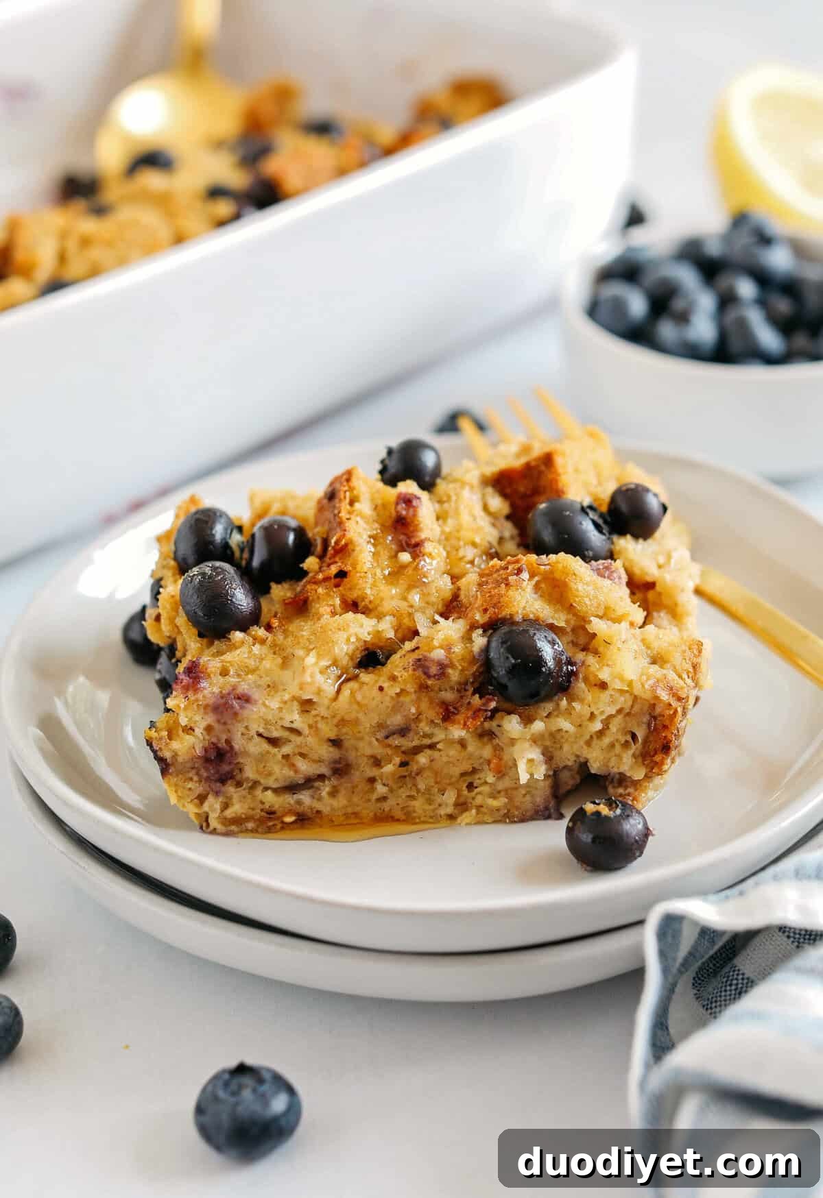 Slices of Blueberry Lemon Bread Pudding garnished with berries