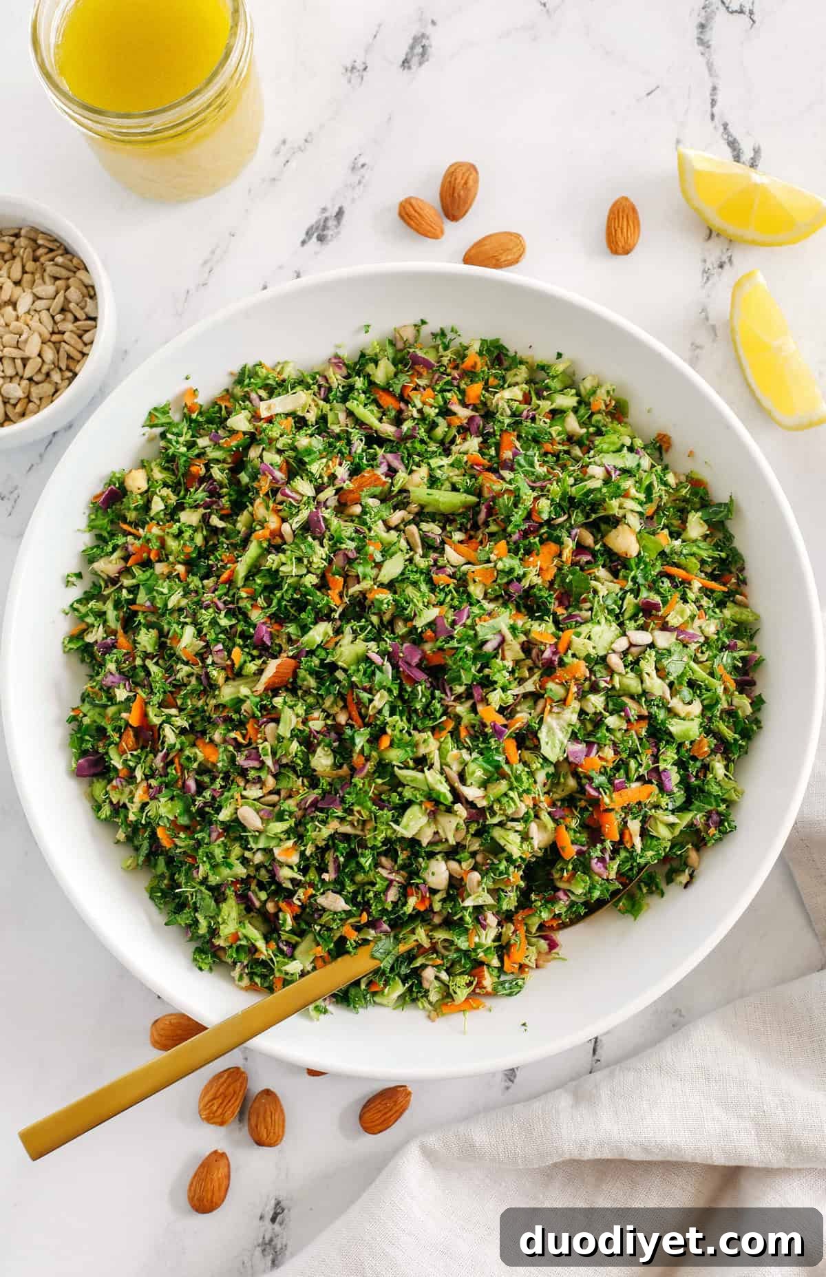 Close-up of the detox salad showing chopped kale, broccoli, brussels sprouts and red cabbage with almonds