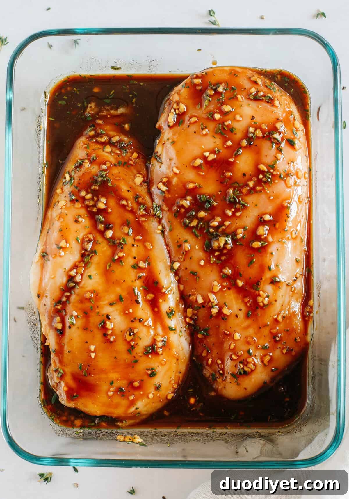 Moist and juicy chicken breasts marinated in a rich maple balsamic herb glaze, seasoned with fresh herbs, and grilled to perfection for a healthy weeknight meal!