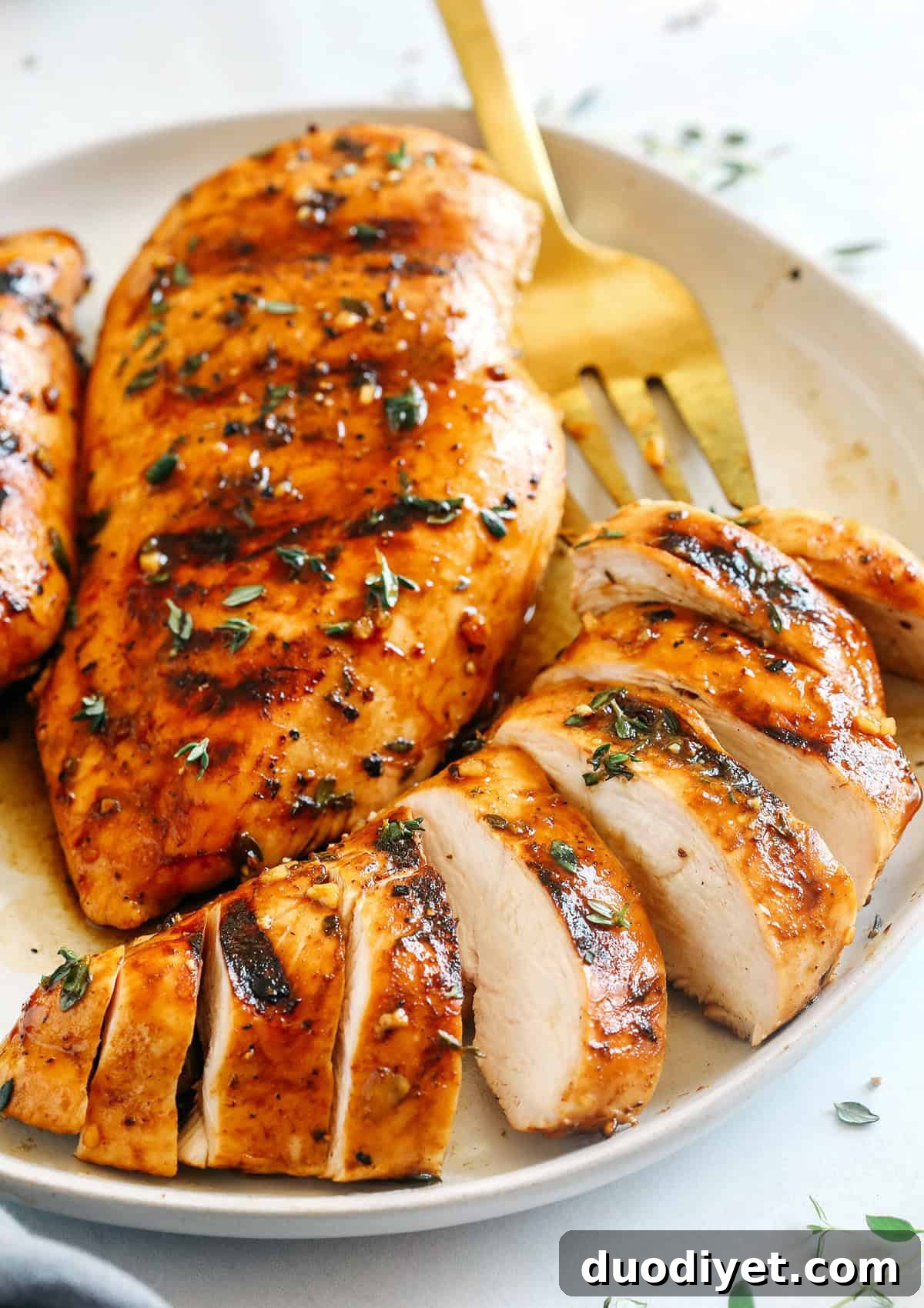 Moist and juicy chicken breasts marinated in a rich maple balsamic herb glaze, seasoned with fresh herbs, and grilled to perfection for a healthy weeknight meal!