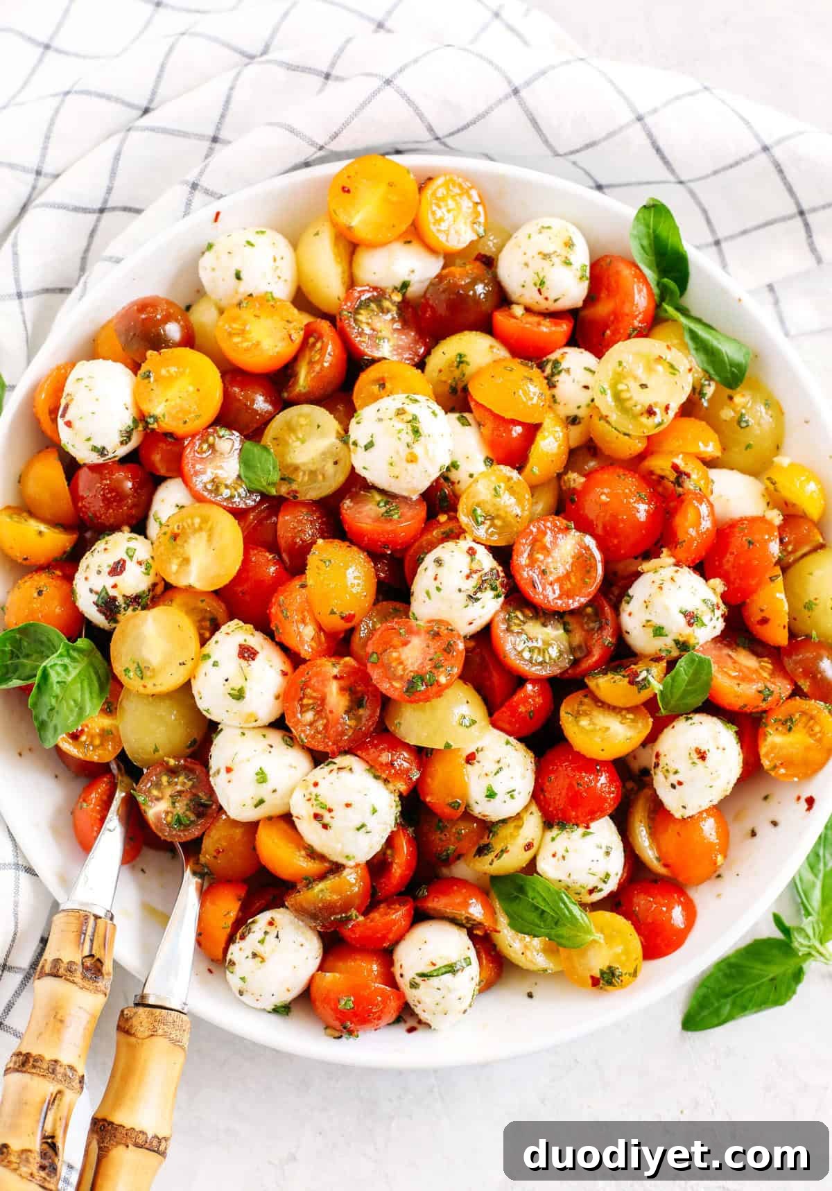 This Summer Caprese Salad is loaded with juicy tomatoes and creamy balls of mozzarella cheese all marinated in a delicious combination of olive oil, balsamic vinegar, garlic and fresh herbs!
