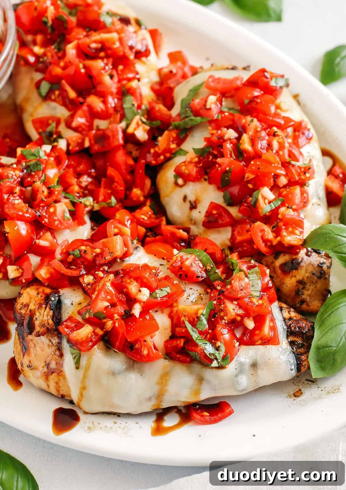 This Grilled Bruschetta Chicken is super easy to make and marinated in the most delicious lemon balsamic dressing all topped with melty mozzarella cheese and fresh tomato bruschetta for the perfect summer meal!