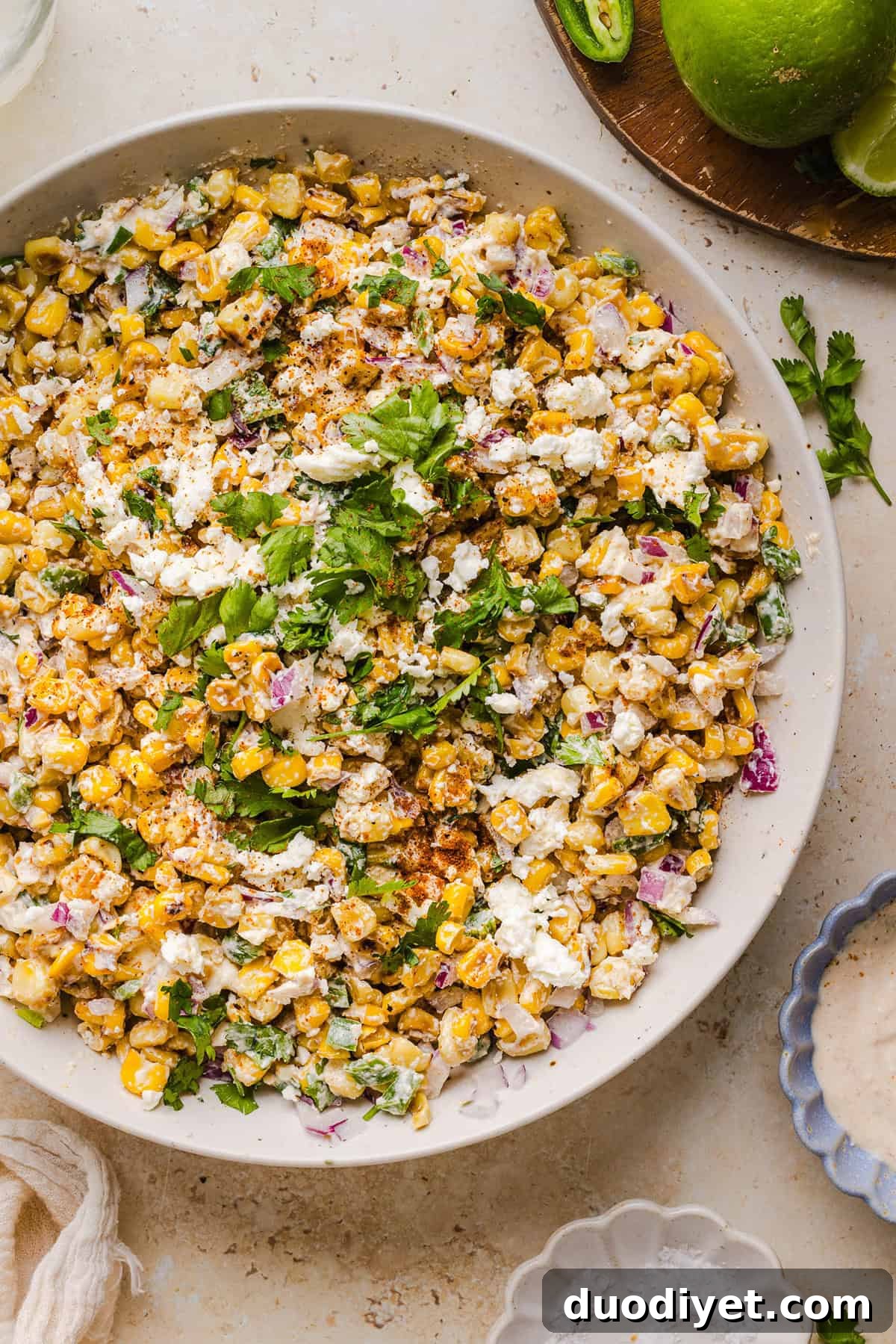 This Healthy Mexican Street Corn Salad is a fresh and flavorful summer side dish loaded with sweet grilled corn, cotija cheese, cilantro, jalapeño, and a creamy protein-packed lime dressing. Perfect for cookouts, taco nights and meal prep!
