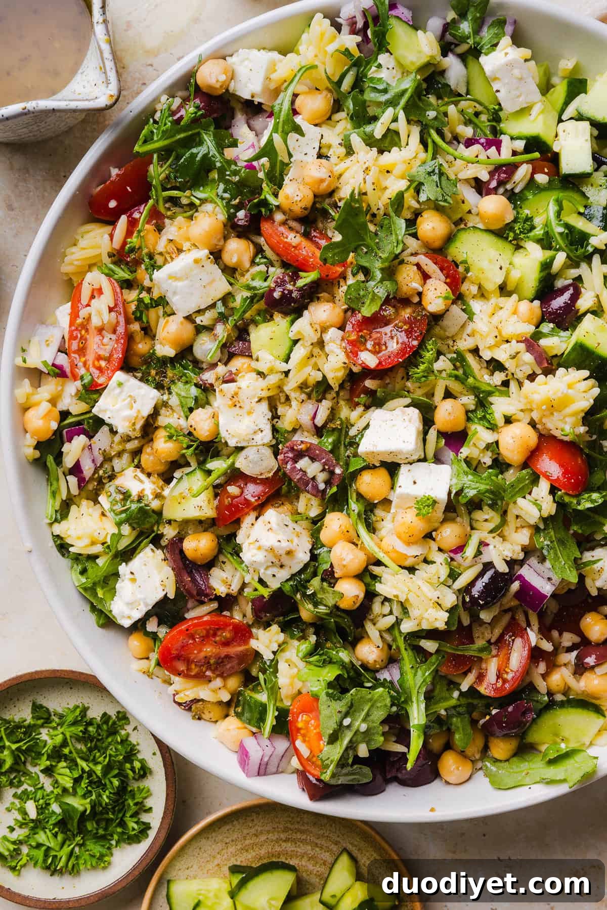 This Easy Greek Orzo Salad is packed with fresh veggies, chickpeas, feta, and the most delicious homemade lemon herb dressing. Perfect for meal prep, picnics, and summer cookouts!