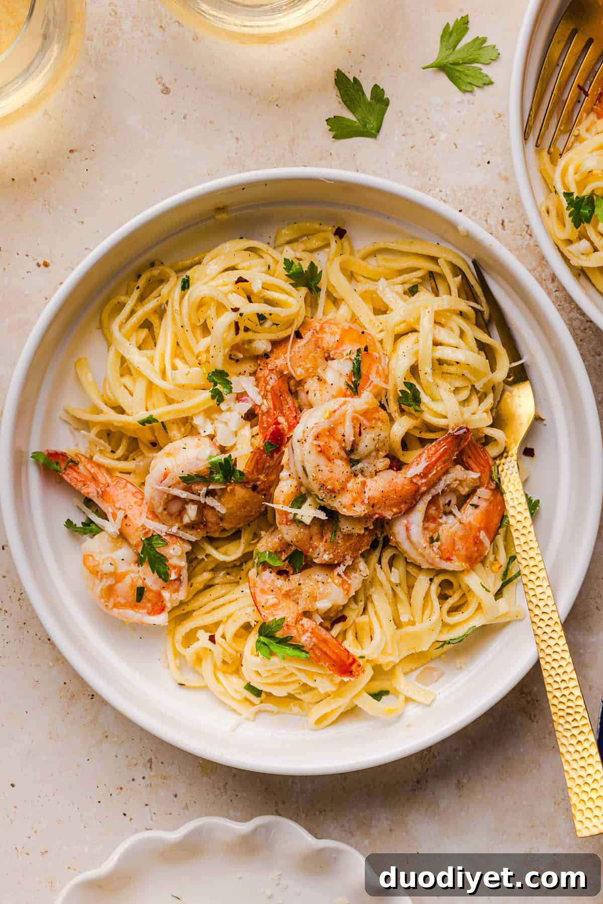 The BEST Healthy Shrimp Scampi recipe lightened up without sacrificing flavor! Juicy shrimp, garlic, lemon, white wine, and Parmesan are tossed with tender linguine in a silky, buttery sauce that’s ready in just 30 minutes.