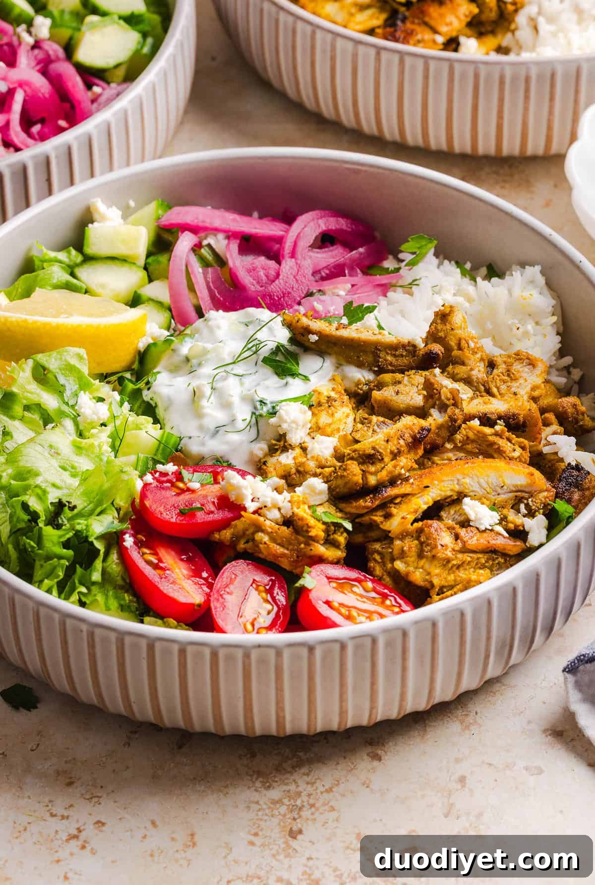 These Easy Chicken Shawarma Bowls are loaded with juicy spiced chicken, fluffy rice, fresh veggies, feta and creamy homemade tzatziki! A healthy, flavor-packed meal that is great for meal prep!
